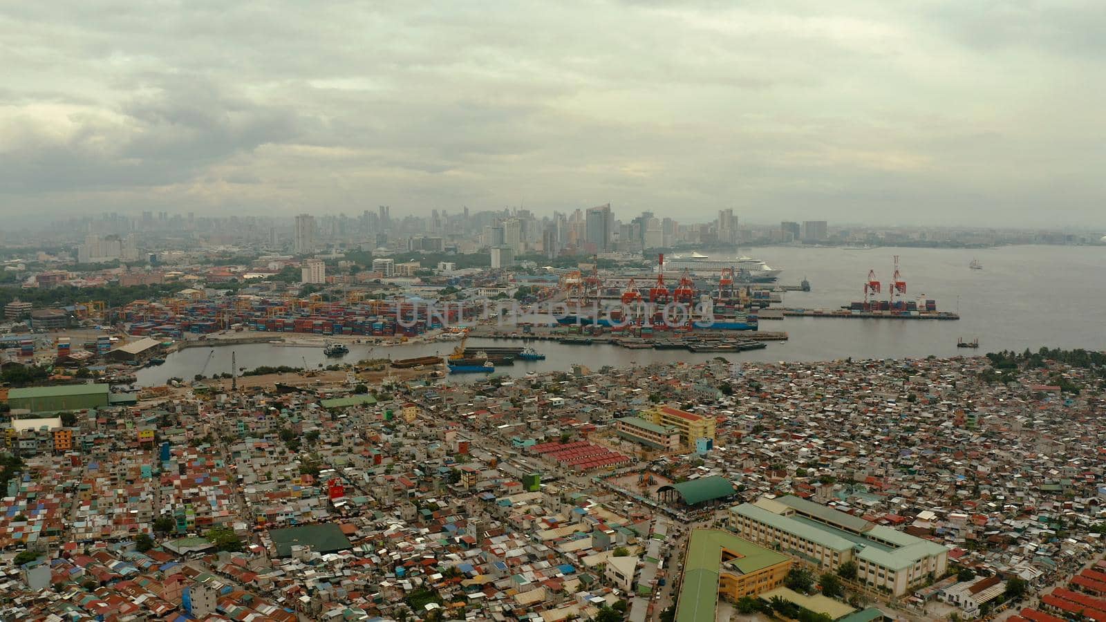 Manila city with port, skyscrapers, modern buildings and Makati business center aerial drone. Travel vacation concept