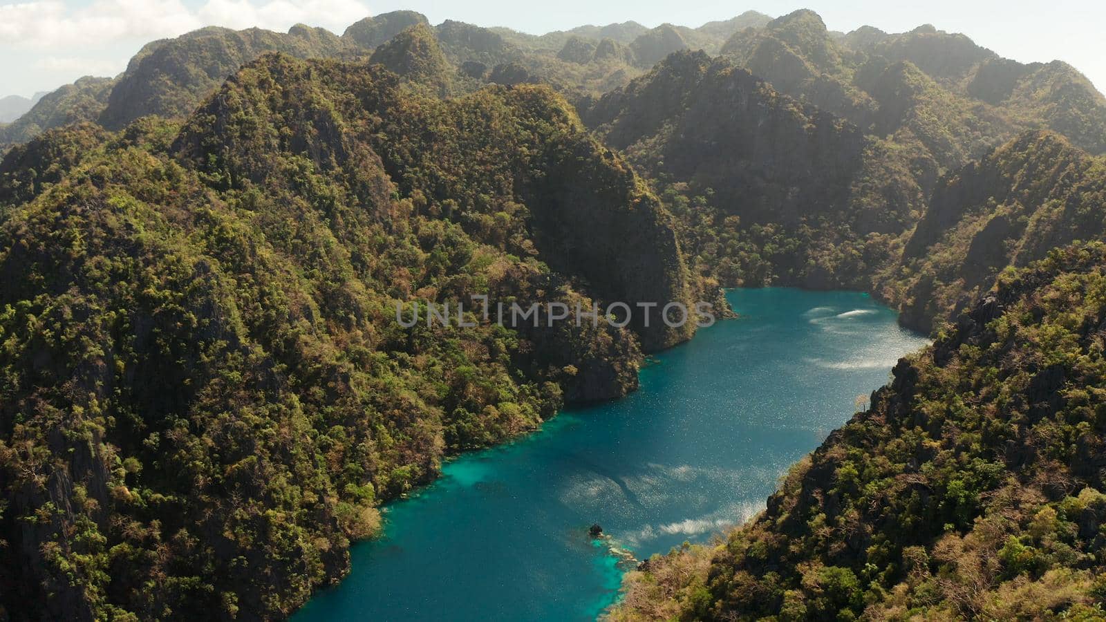 Aerial drone Kayangan lake with blue water on tropical island Coron. Lake in the mountains covered with tropical forest. Palawan, Philippines