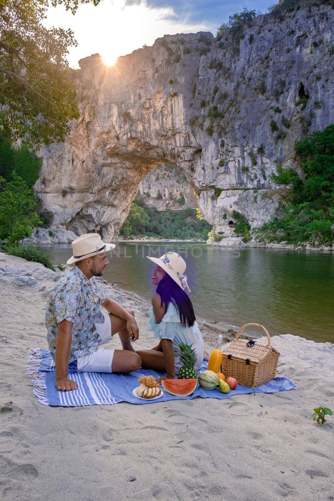 couple men and woman visiting The famous natural bridge of Pont d'Arc in Ardeche department in France Ardeche. Europe Rhone Alpes