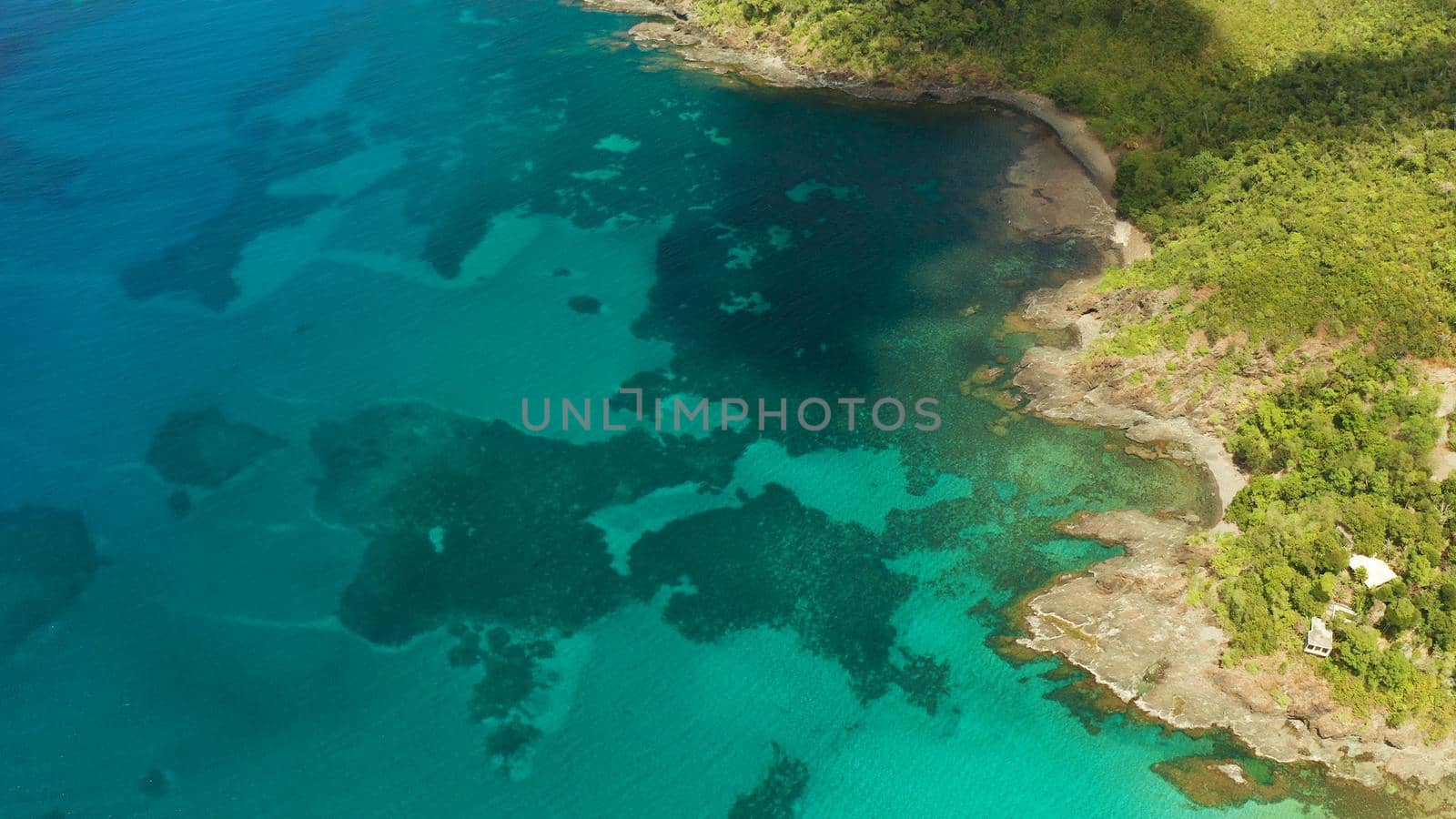 Aerial view turquoise water in the lagoon and coral reef. Palawan, Philippines. Seascape island and clear blue water tropical landscape