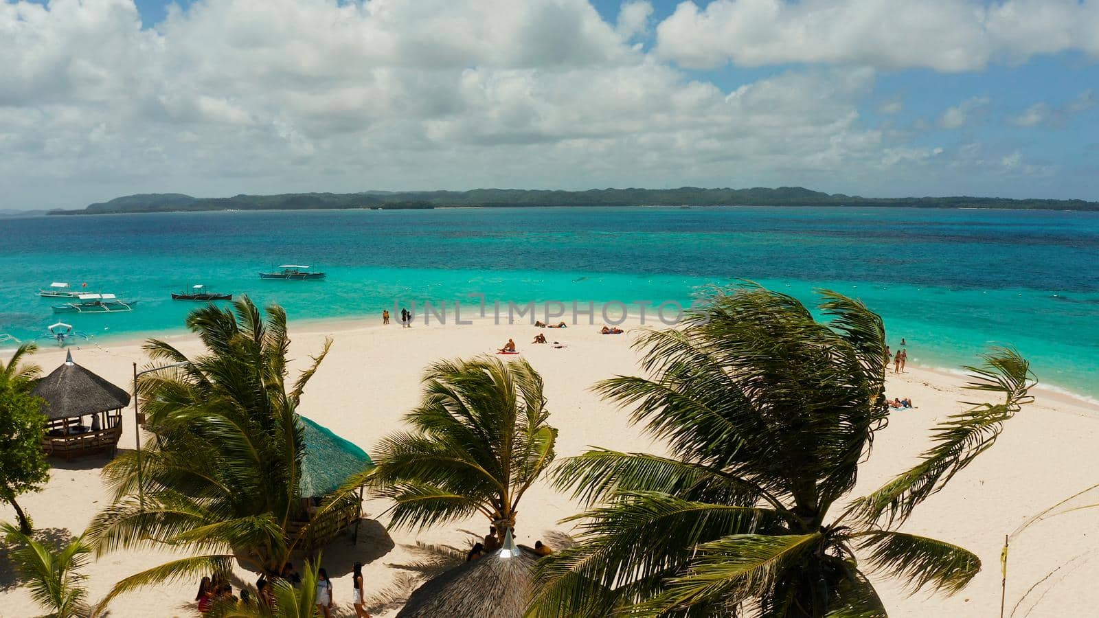 Tropical landscape: Daco island with beautiful beach, palm trees by turquoise water view from above. Siargao, Philippines. Summer and travel vacation concept