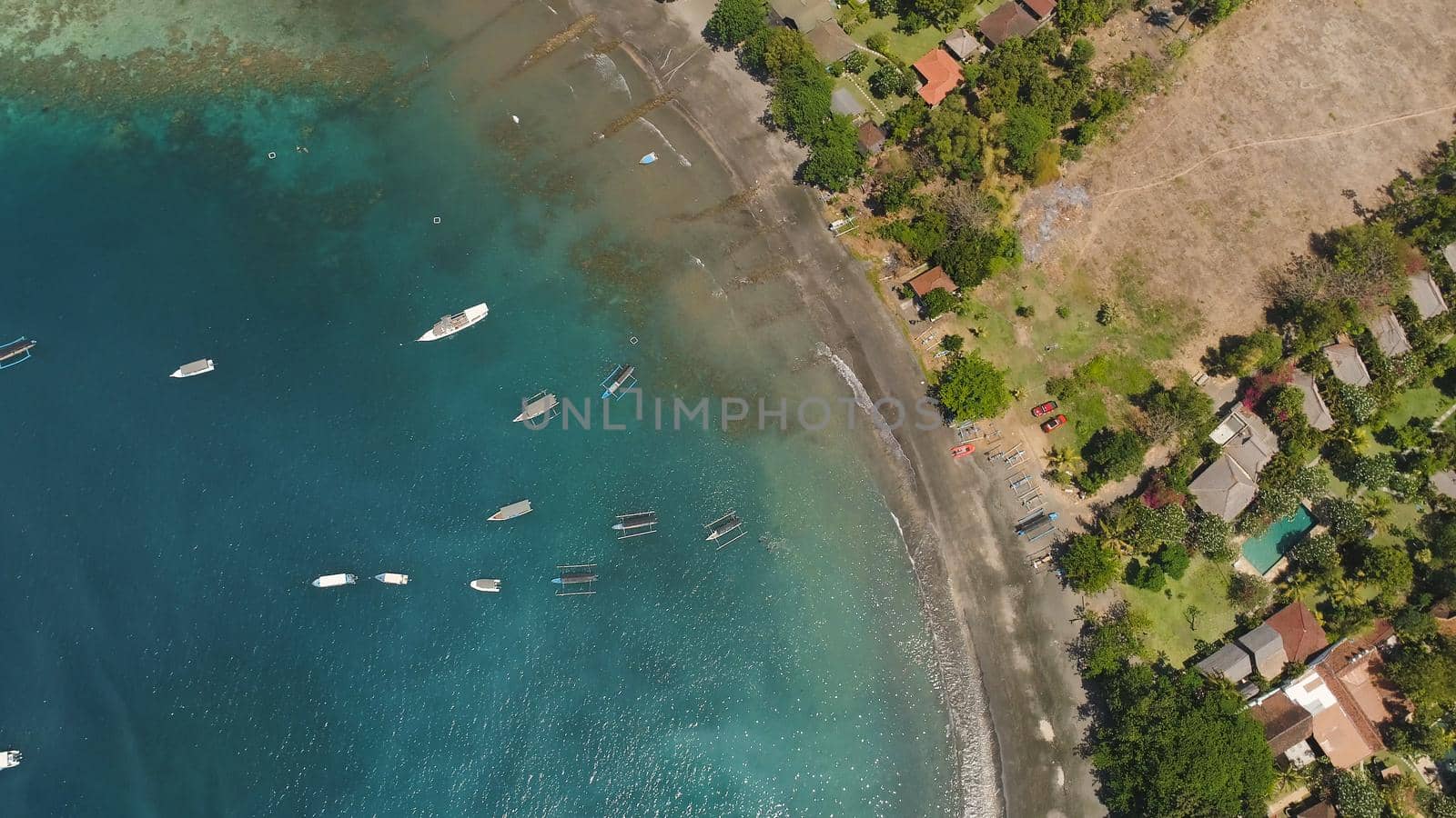 Lagoon with turquoise water and the beach in the sea bay aerial view tropical landscape, sea, boats on the surface of the water. Bali,Indonesia, travel concept.