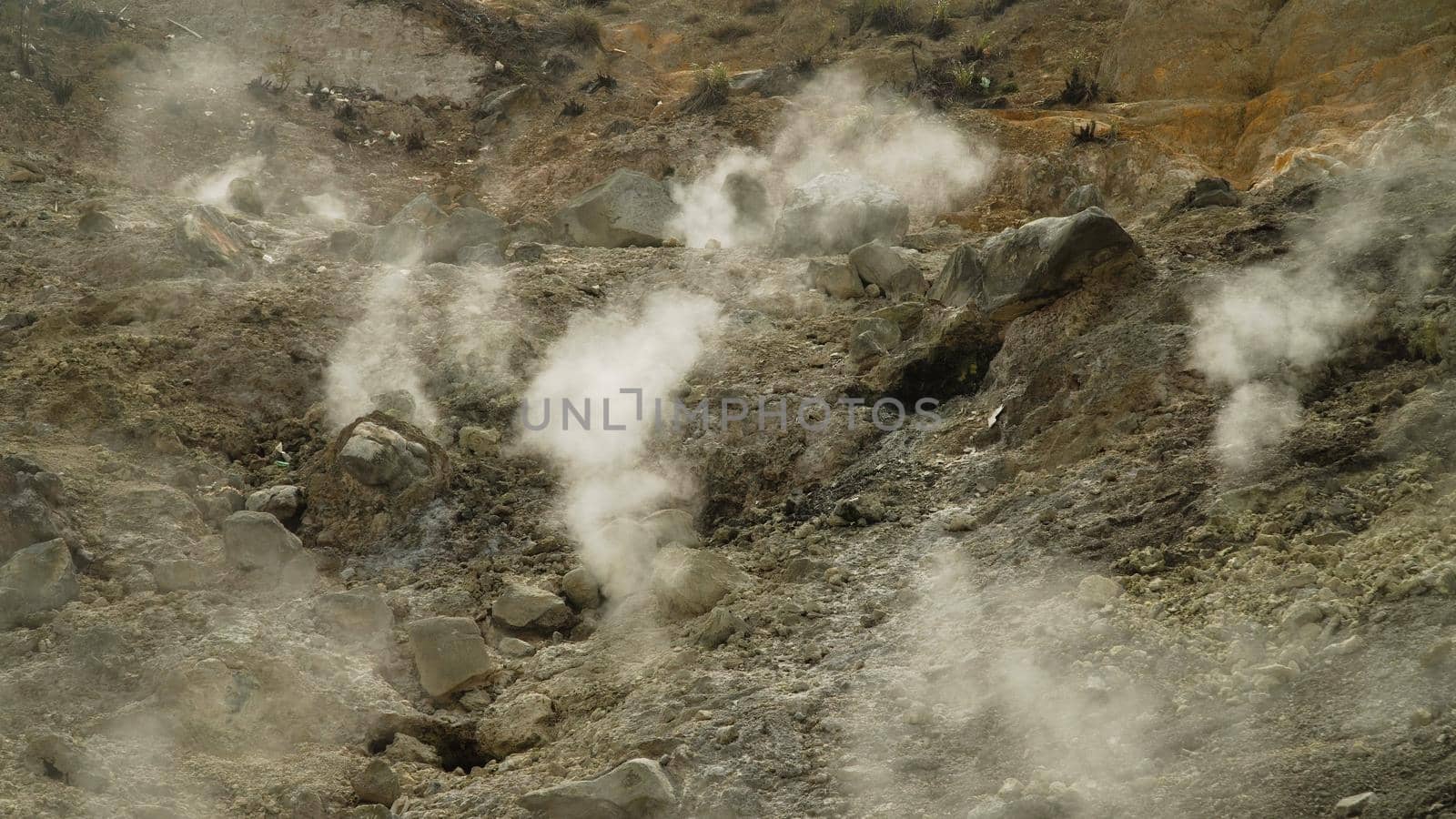 plateau with geothermal volcanic activity, geysers. volcanic landscape Dieng Plateau, Indonesia. Famous tourist destination of Sikidang Crater it still generates thick sulfur fumes.