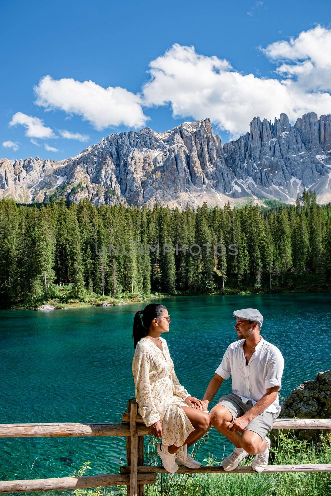 The majestic Lake of Lago di Carezza, beautiful green and turquoise colors in Dolomites mountains Italy,South tyrol, Italy. Landscape of Lake Carezza or Karersee  by fokkebok