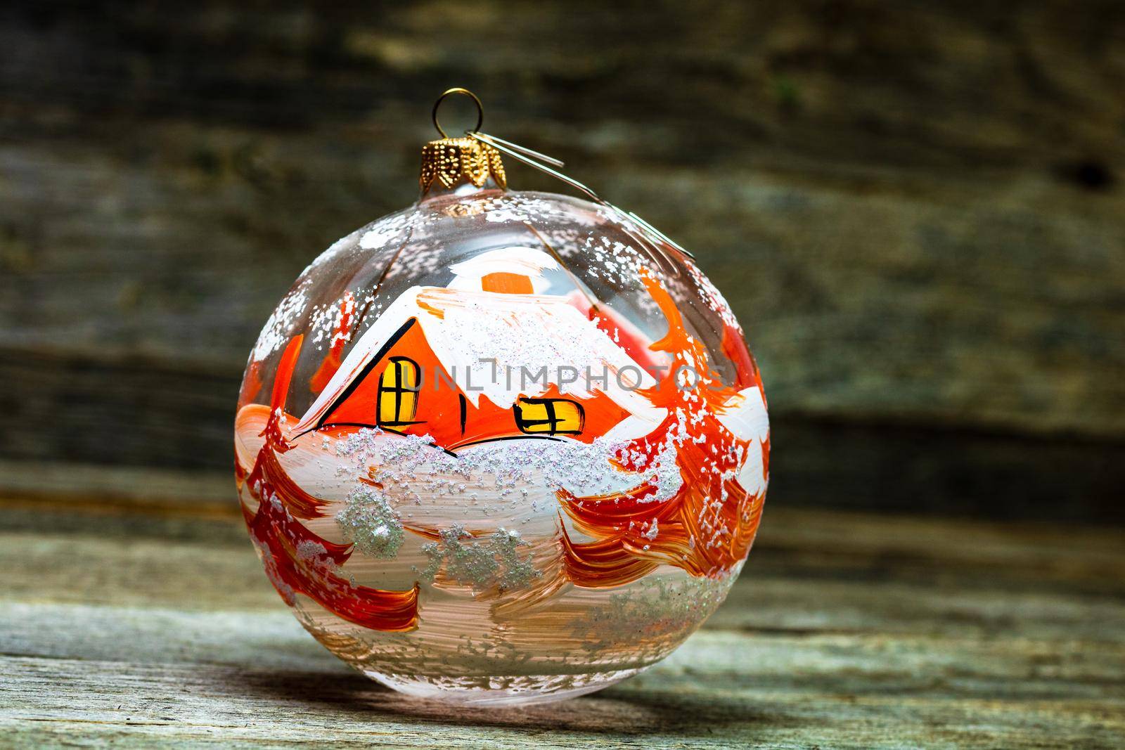 Close up of decorated glass Christmas ball bauble on wooden background, by vladispas