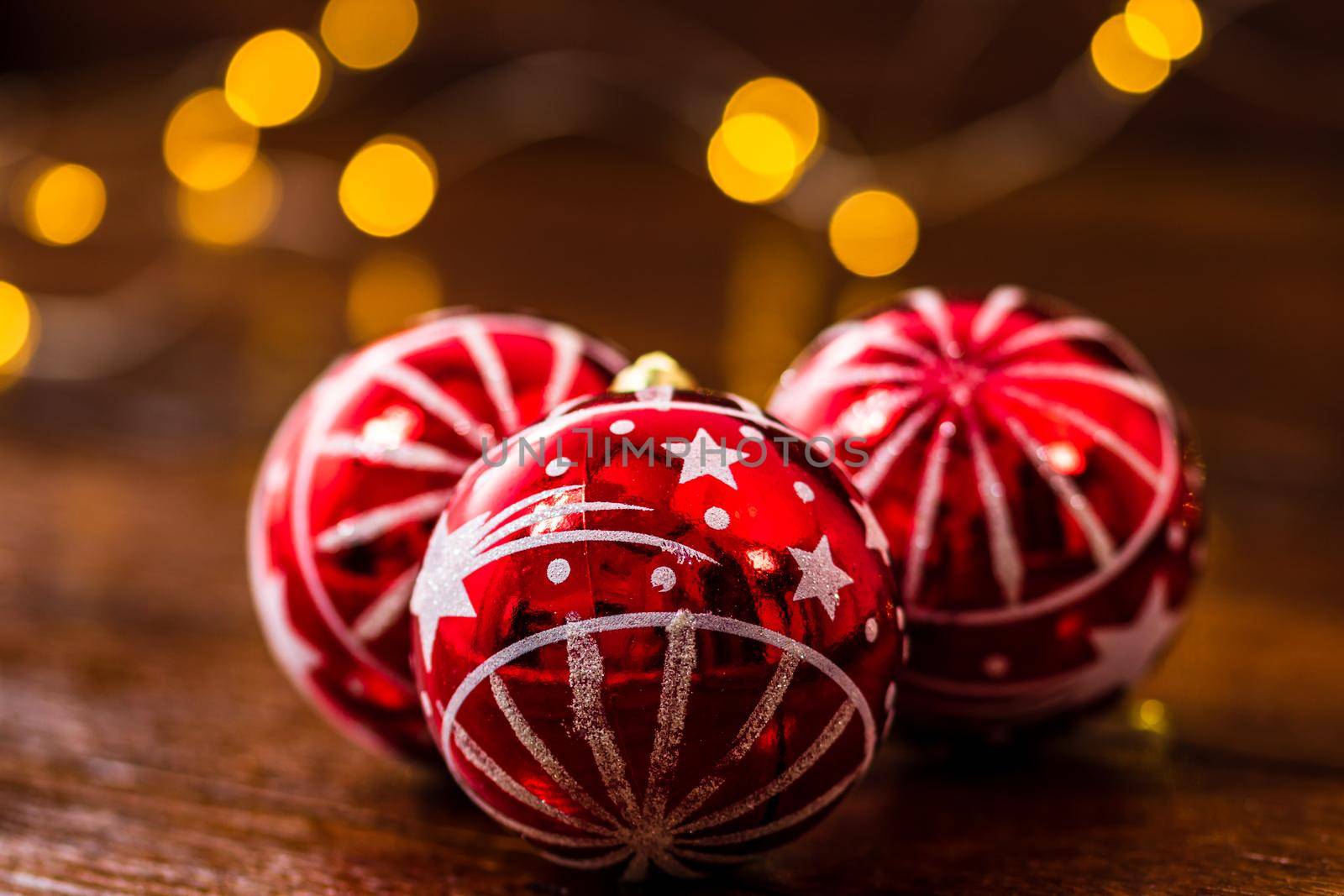 Red Christmas balls isolated on blurred and shiny background of lights. Christmas baubles isolated.