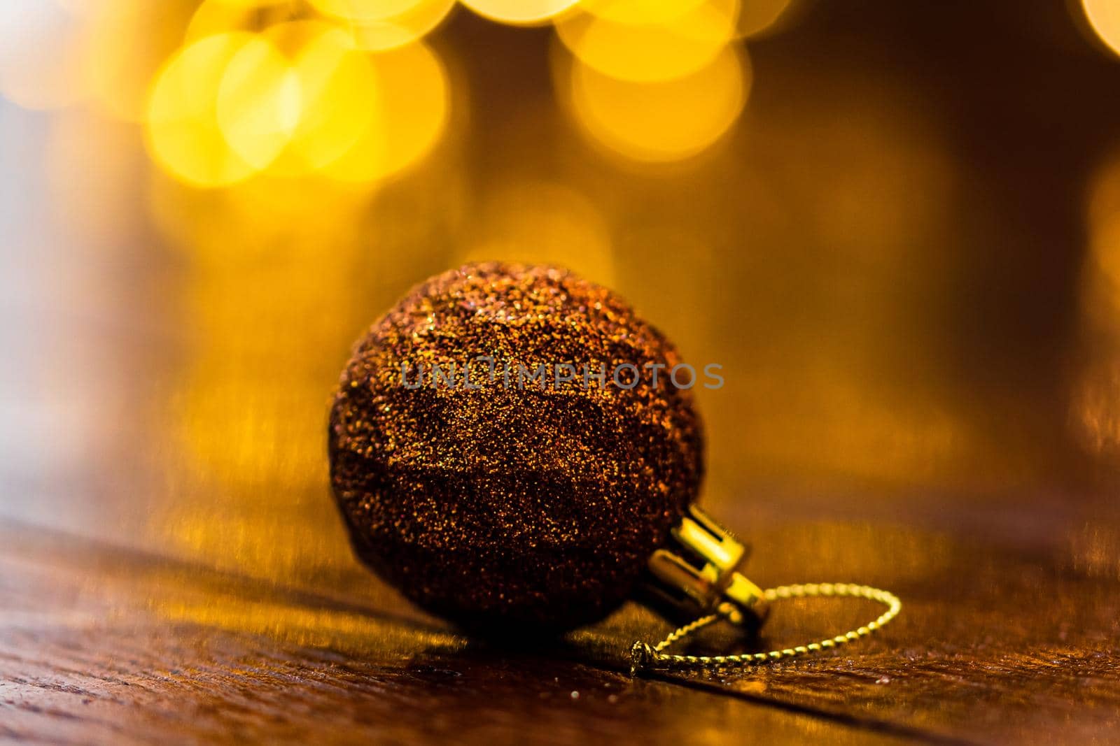 Colorful Christmas ball isolated on blurred and shiny background of lights. Christmas baubles isolated. by vladispas