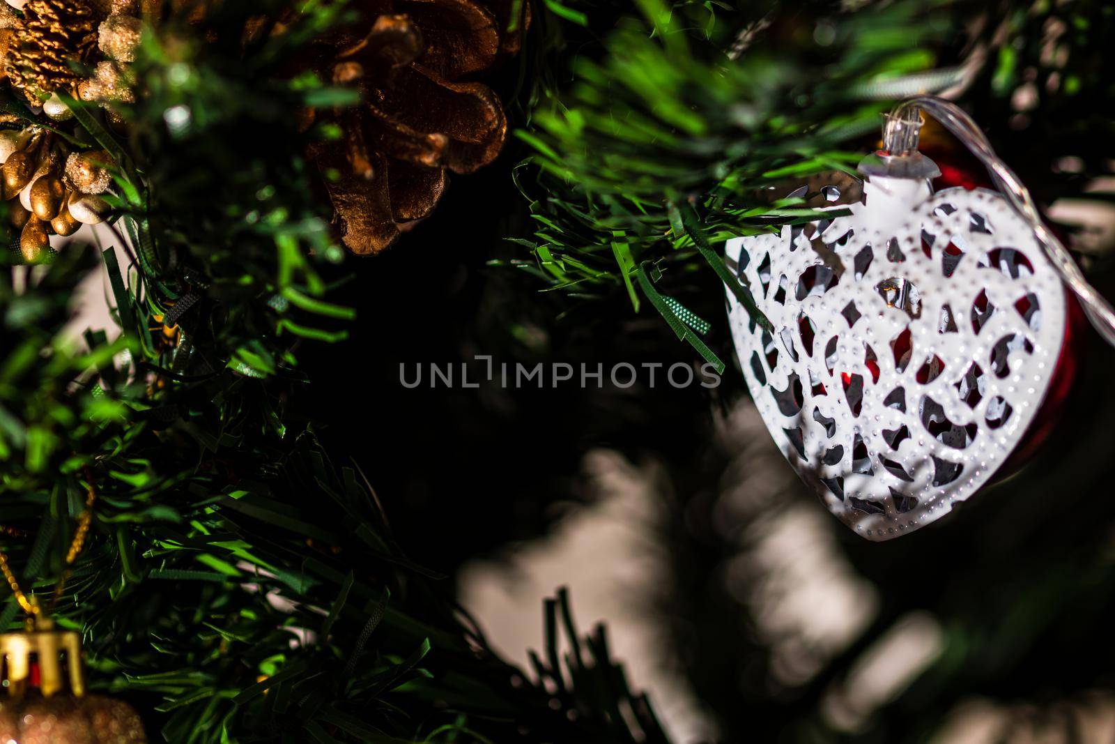 Christmas hanging decorations on fir tree. Decorated Christmas tree. Fir branch with Christmas baubles decorations.