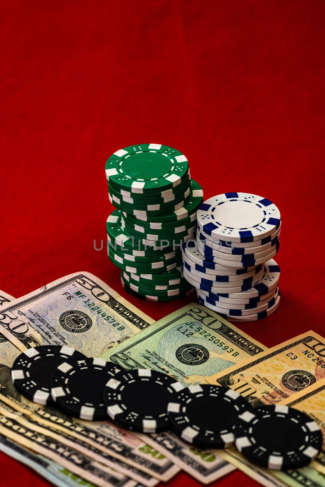 Stacks of poker chips with money on red background, USD currency
