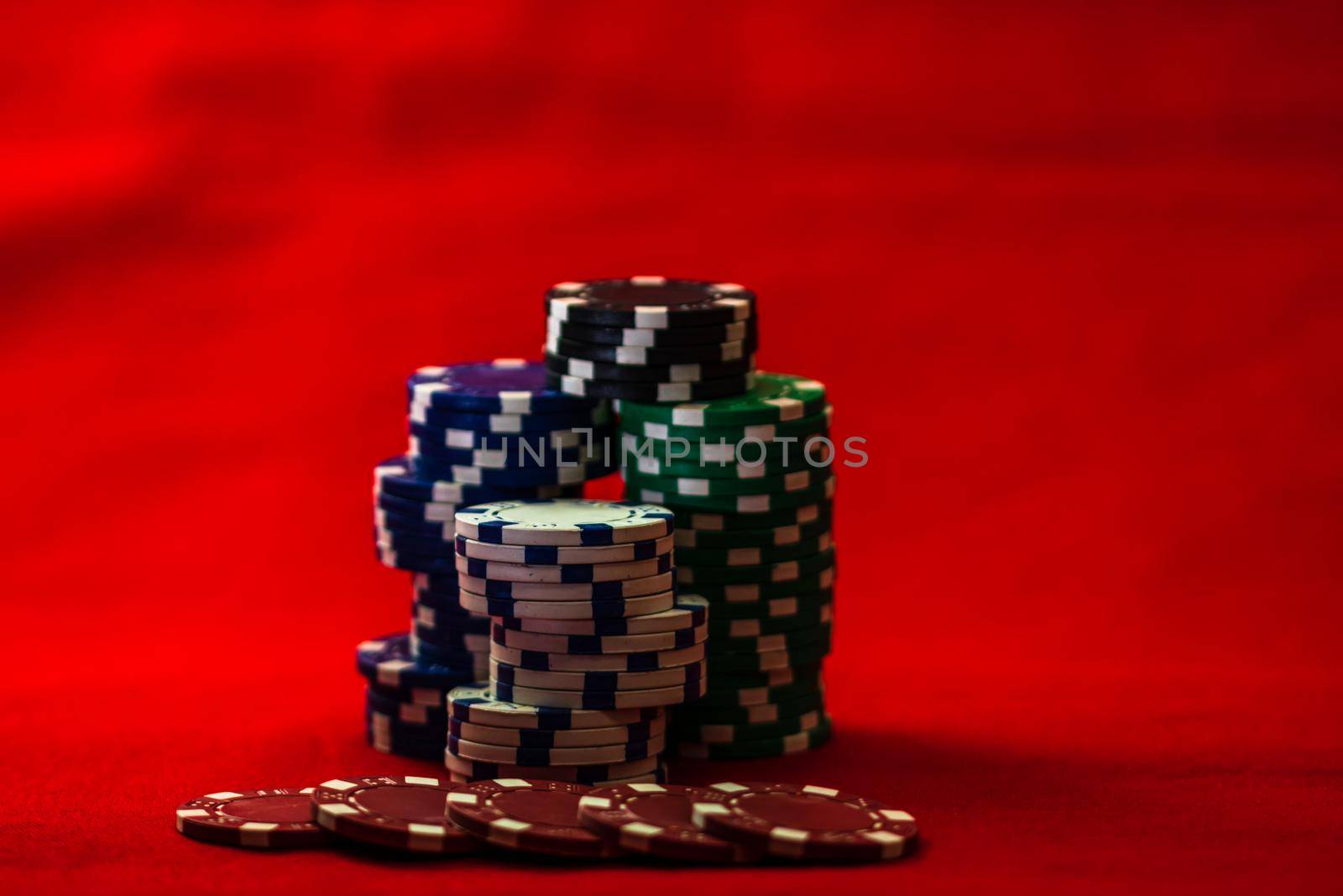 Mix of poker chips on red background by vladispas