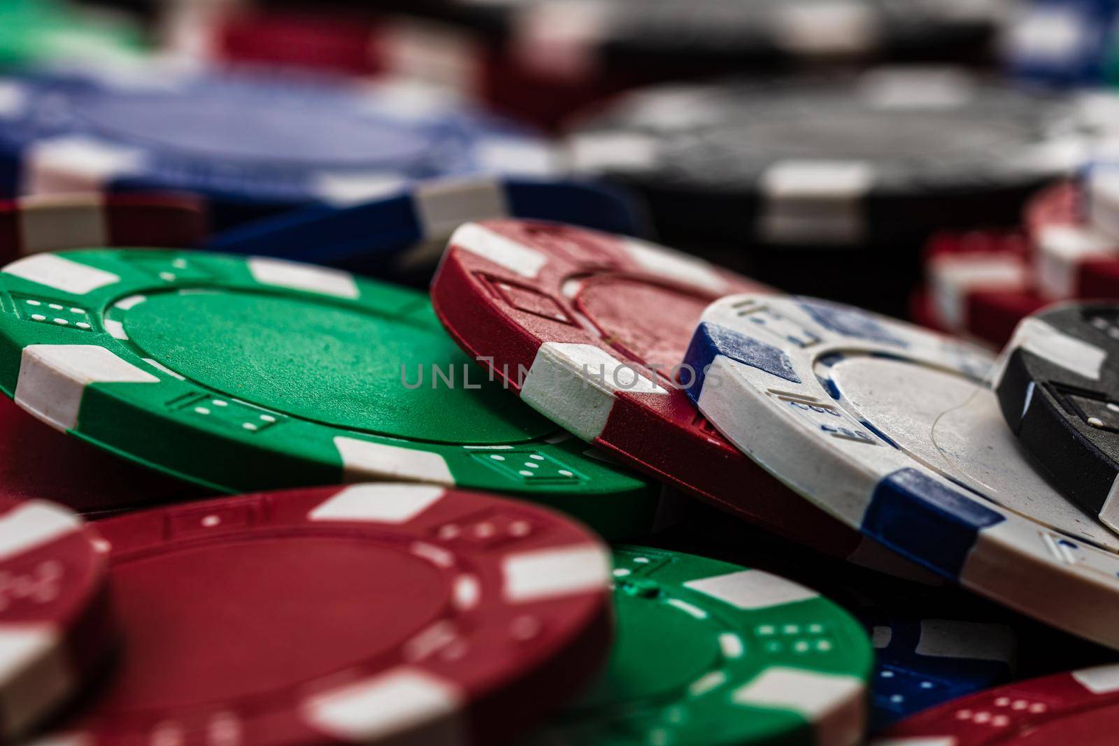 Poker chips close up background. Casino concept, risk, chance, good luck or gambling. Detail of casino chips by vladispas