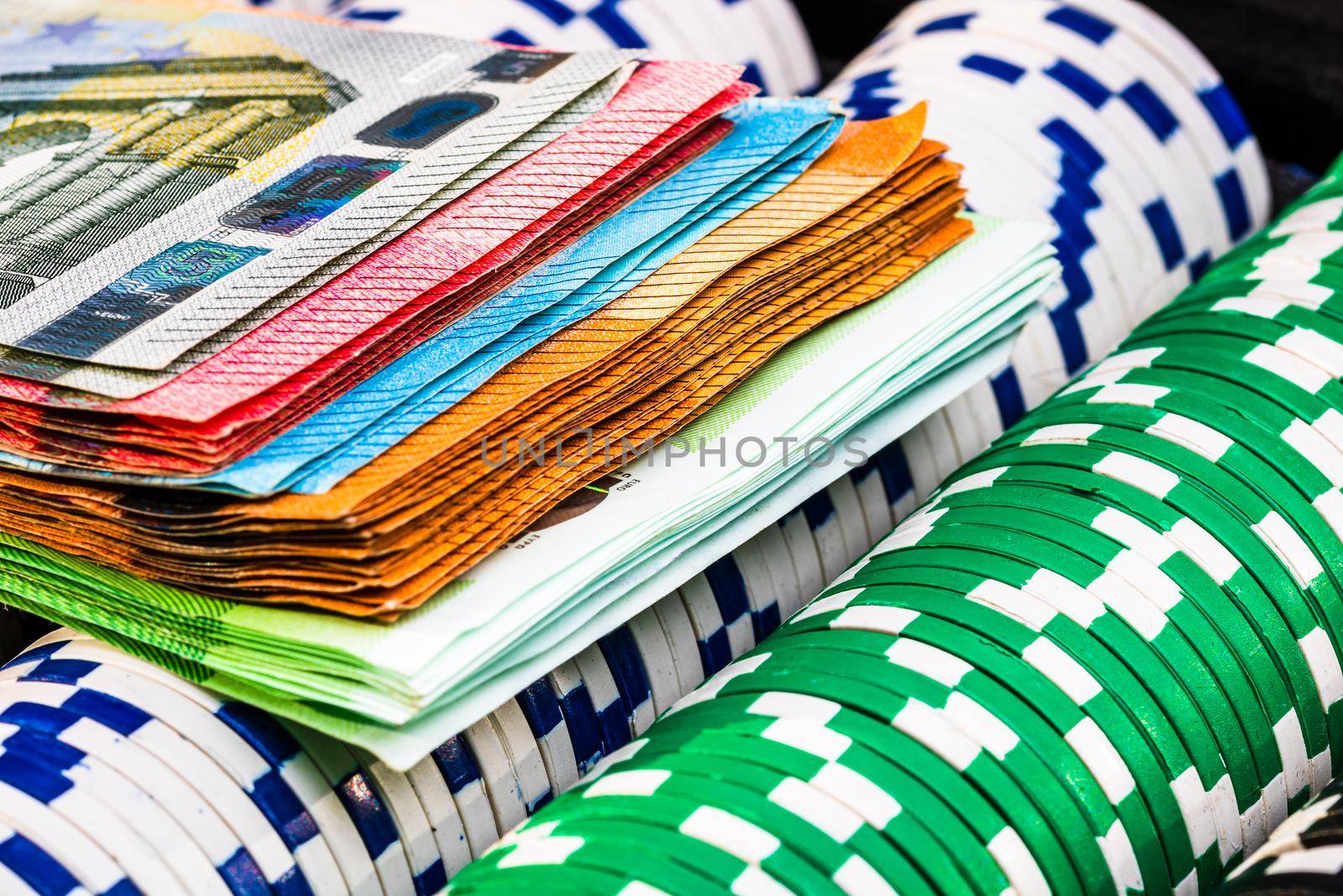 Poker game concept. Casino concept for business, risk,chance, good luck or gambling. Stack of Poker chips and euro money, close up, isolated.