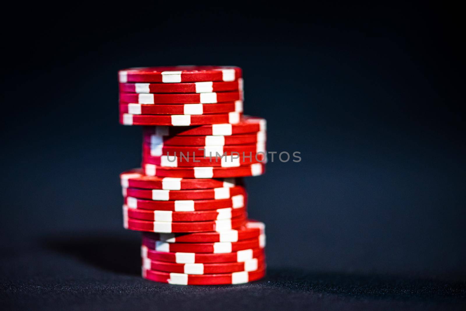 Stack of poker chips on black background by vladispas