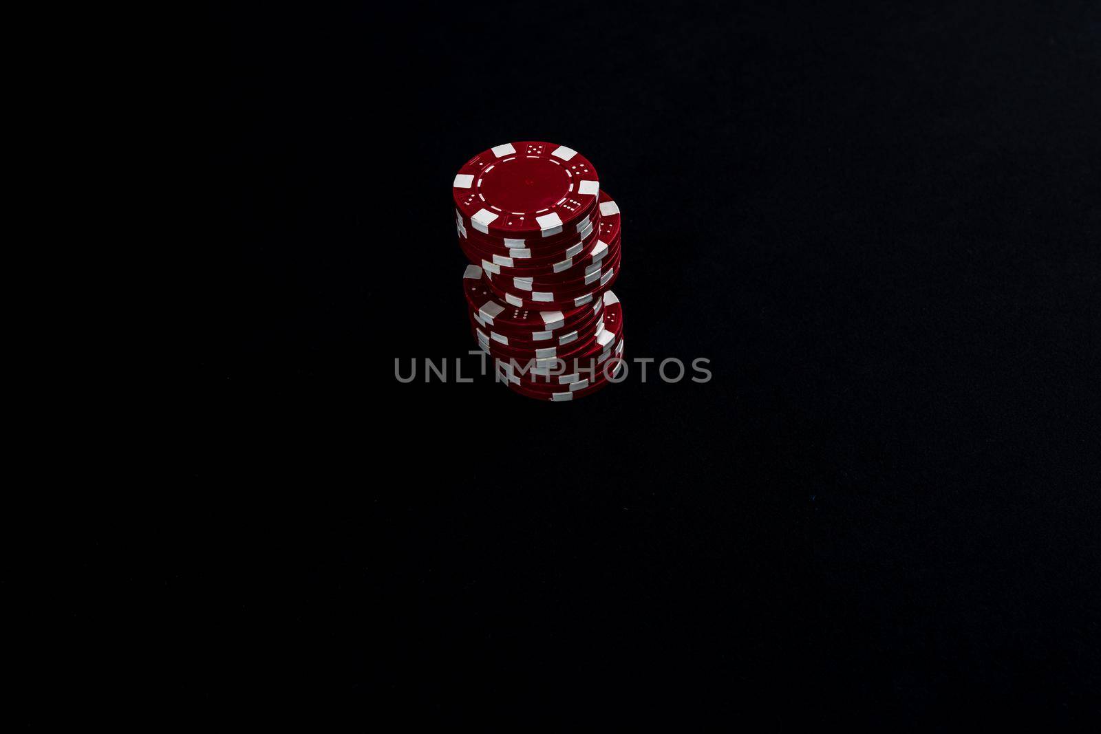 Stack of poker chips on black background by vladispas