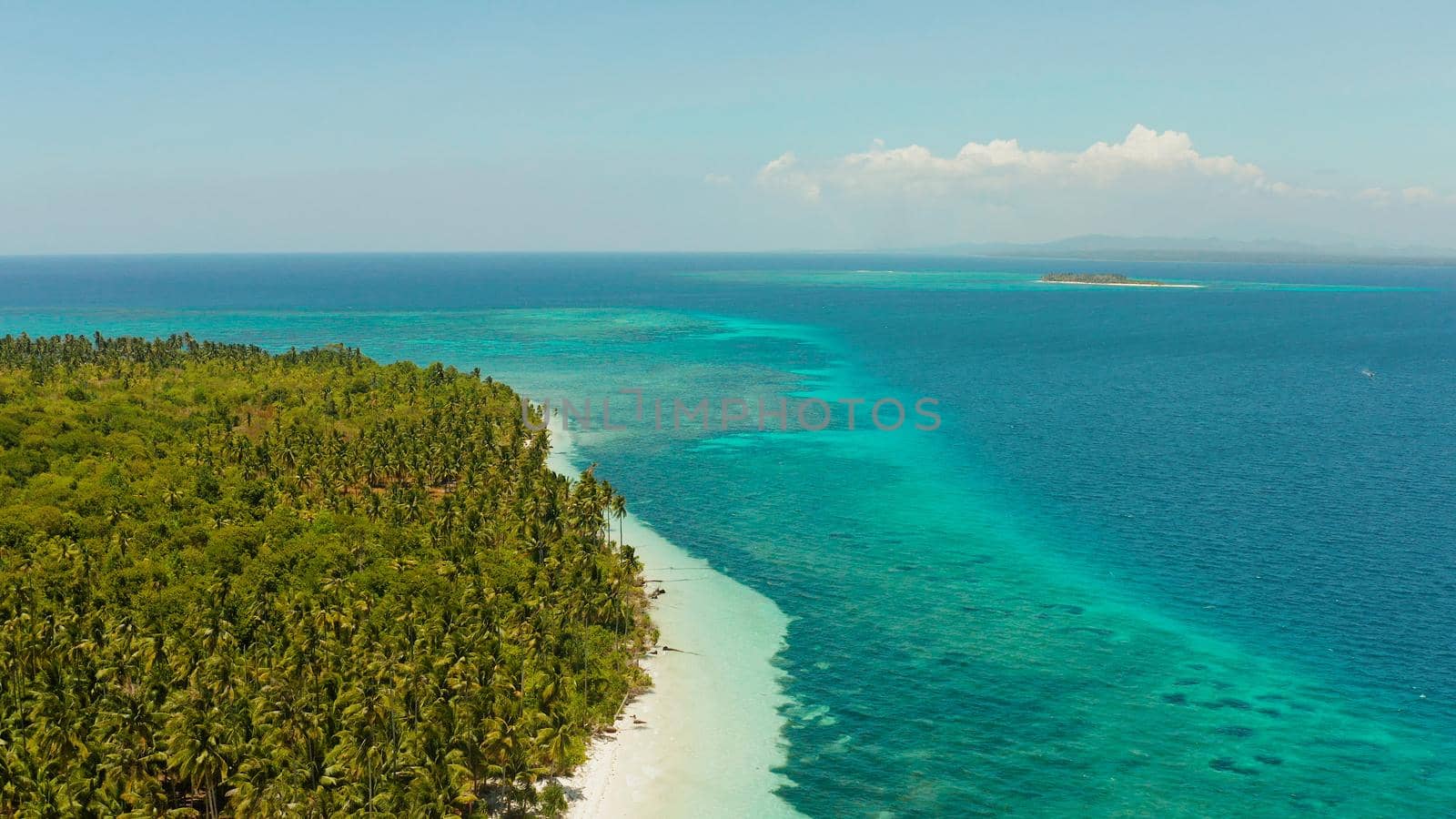 Tropical landscape: small island with beautiful beach, palm trees by turquoise water view from above. Patongong Island with sandy beach. Summer and travel vacation concept.