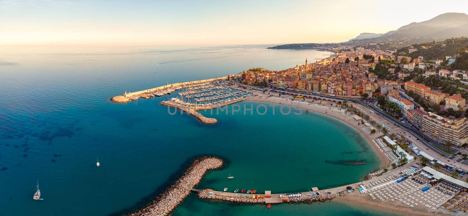  Sand beach beneath the colorful old town Menton on french Riviera, France. Drone aerial view over Menton France Europe