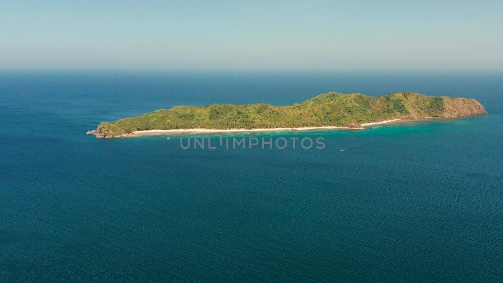 Tropical island with beach and blue water, aerial view. island and mountains covered with tropical forest. El nido, Philippines, Palawan. Summer and travel vacation concept