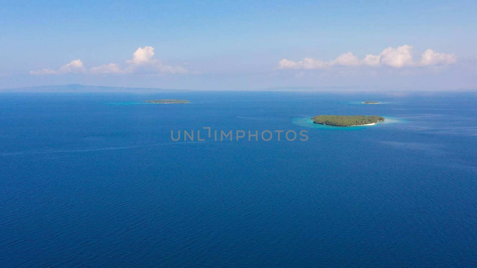 Blue sea and islands with white beaches, top view. Philippine Islands. Seascape with islands in the afternoon. Summer and travel vacation concept.