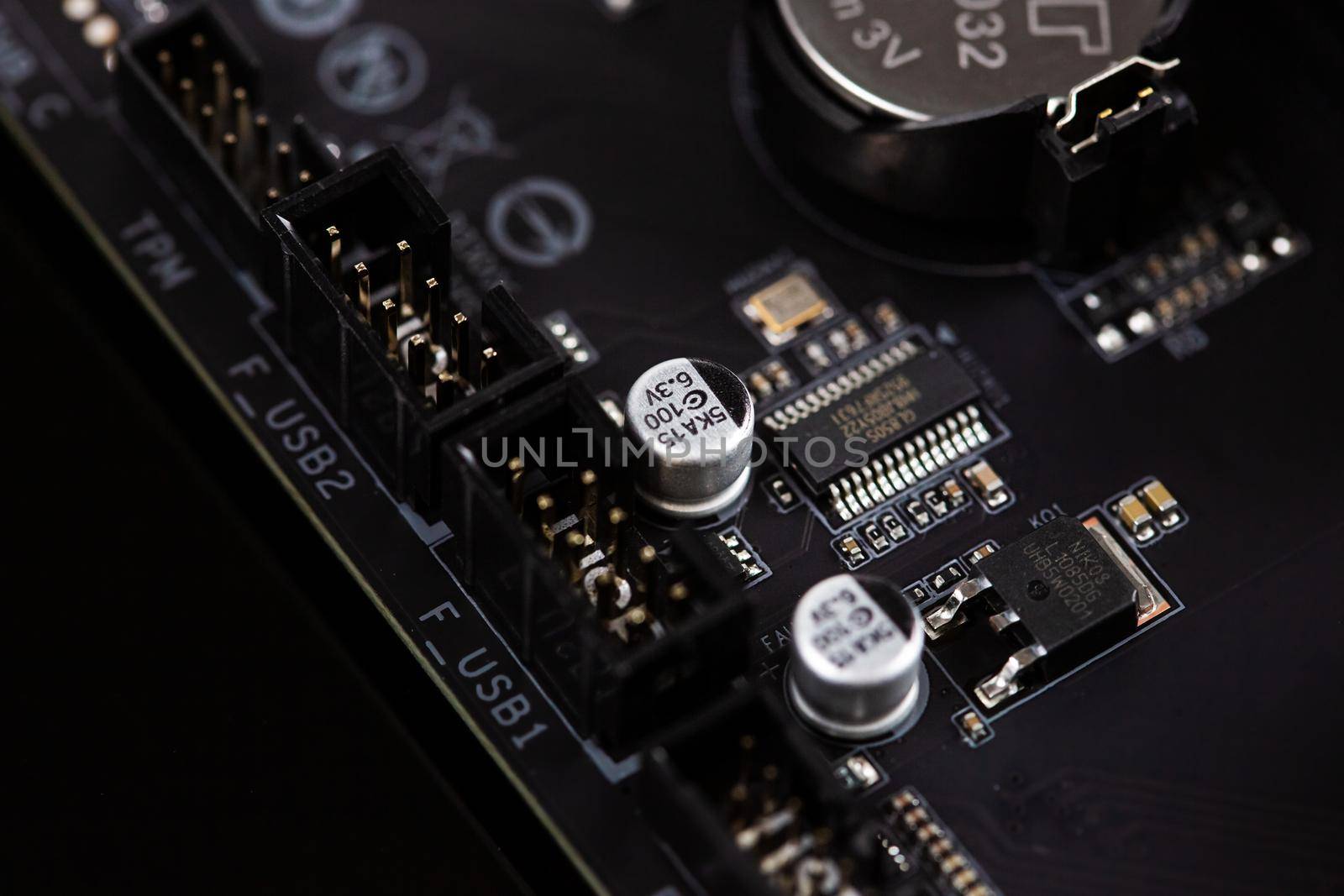 Motherboard on a table close-up, inside of a desktop computer showing chips, circuit boards and components