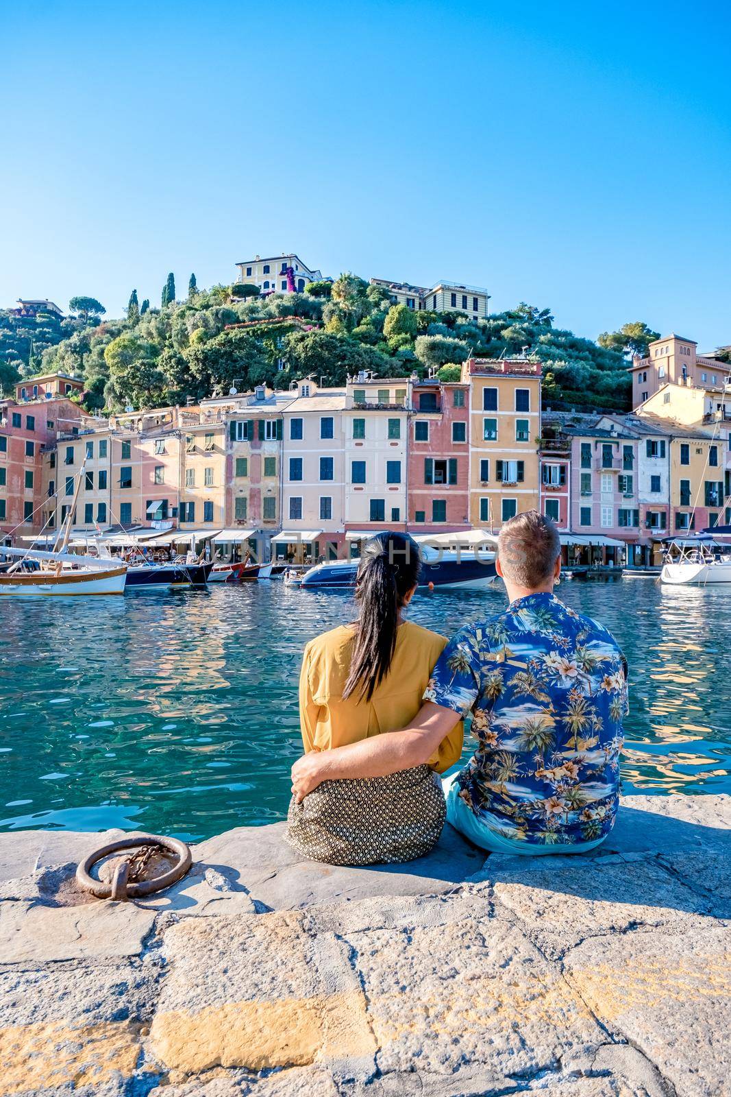 Beautiful sea coast with colorful houses in Portofino, Italy Europe Portofino in Liguria, Italy. Genoa Couple mid age man and woman visiting Italy during vacation