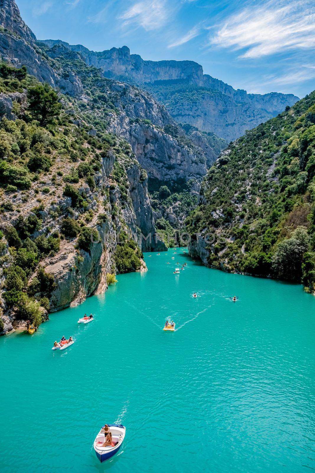 cliffy rocks of Verdon Gorge at lake of Sainte Croix, Provence, France, Provence Alpes Cote d Azur, blue green lake with boats in France Provence. Europe June 2020