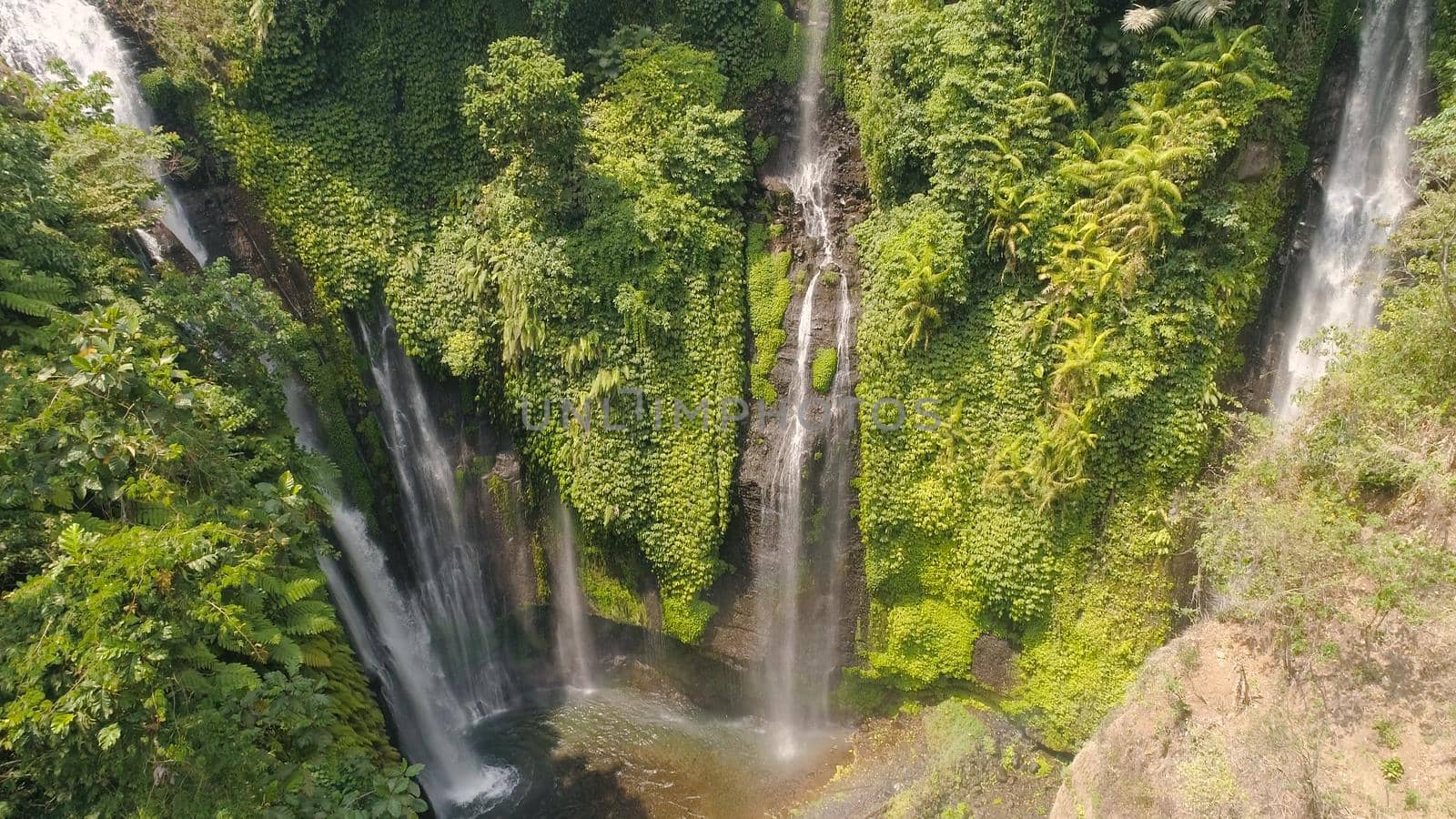 waterfall in green rainforest. Aerial view triple tropical waterfall Sekumpul in mountain jungle. Bali,Indonesia. Travel concept.