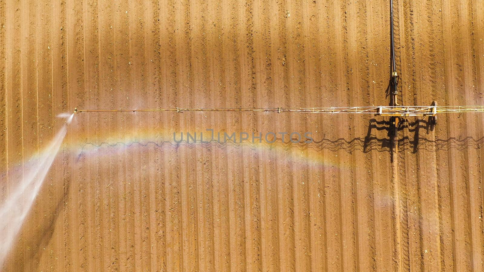 aerial view Center pivot agriculture irrigation machine of crops. An irrigation pivot watering agricultural land. Irrigation system watering farm land.