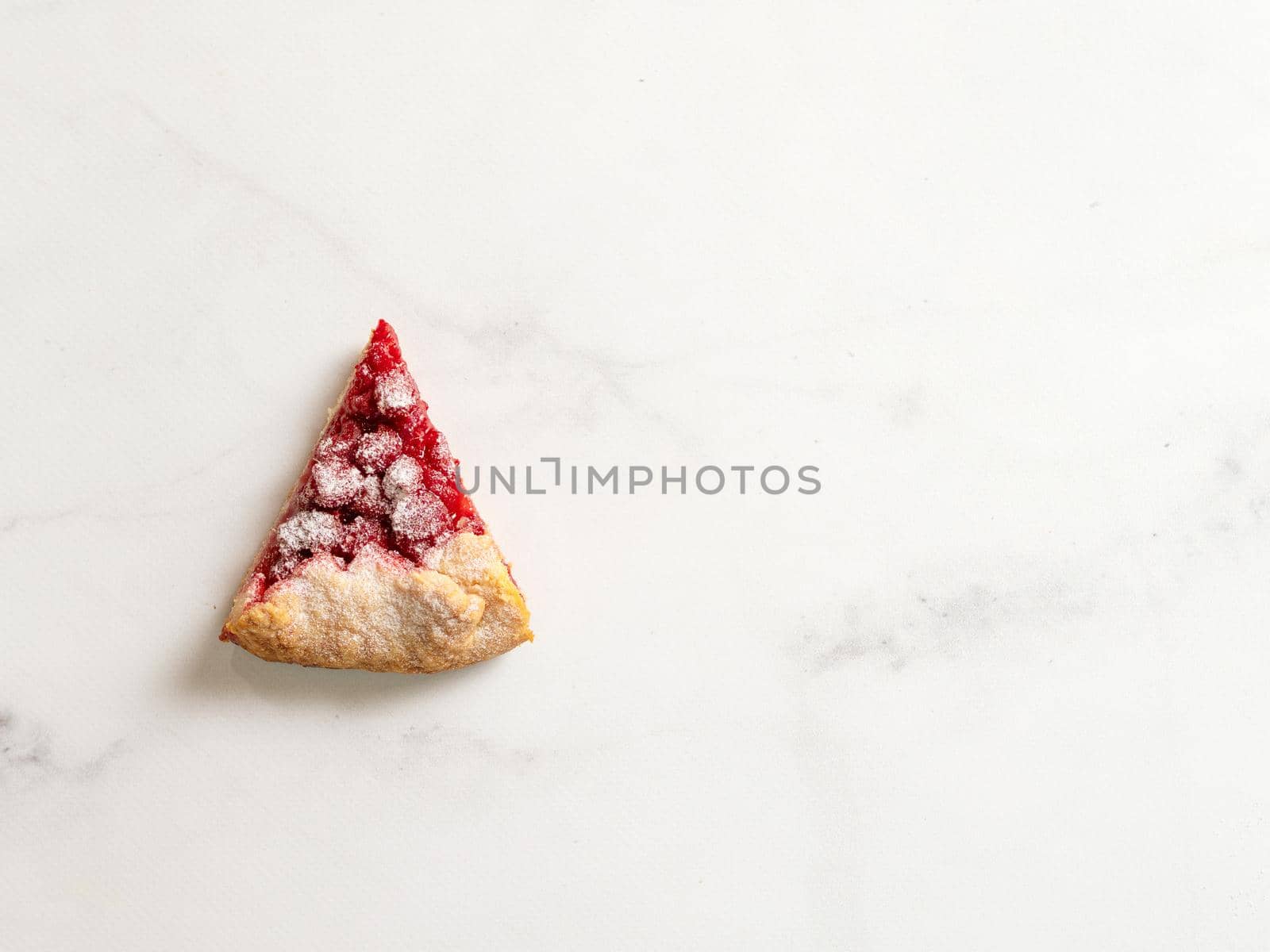 Perfect slice of raspberry galette. Delicious rustic homemade tart with frozen or fresh raspberries, white marble background. Beautiful piece of galette with raspberries,copy space. Top view flat lay