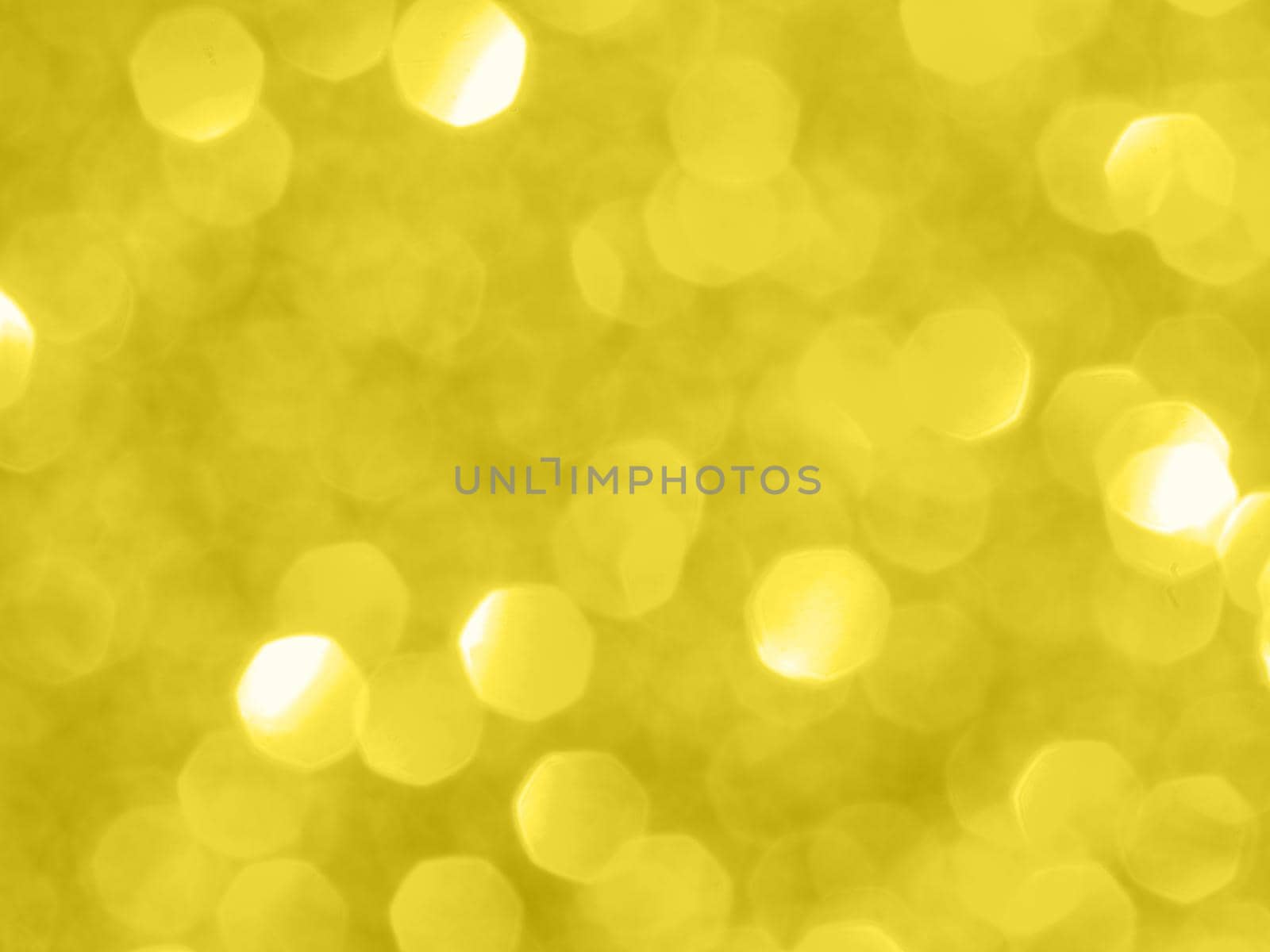 Illuminating yellow - trendy color of the year 2021. Sparkling background with bokeh made of Illuminating yellow 2021 color. Color of year 2021 blurred backdrop for holidays and parties. Copy space