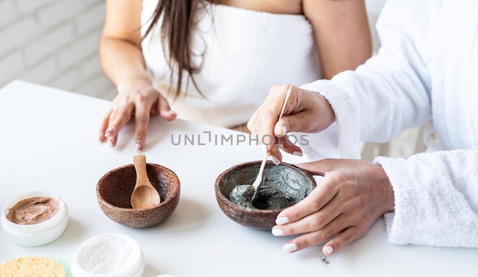 Spa and wellness concept. Self care. Women hands making facial mask doing spa procedures