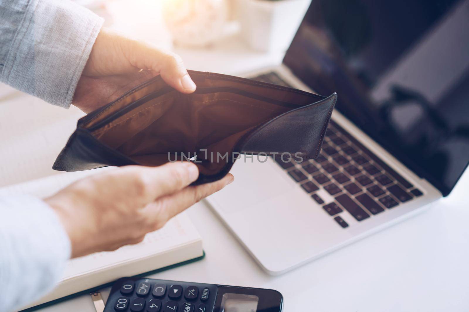 Woman holds an empty purse and coins in hand meaning money financial problem or bankrupt jobless, broke after credit card payday jobless, debt. by Suwant