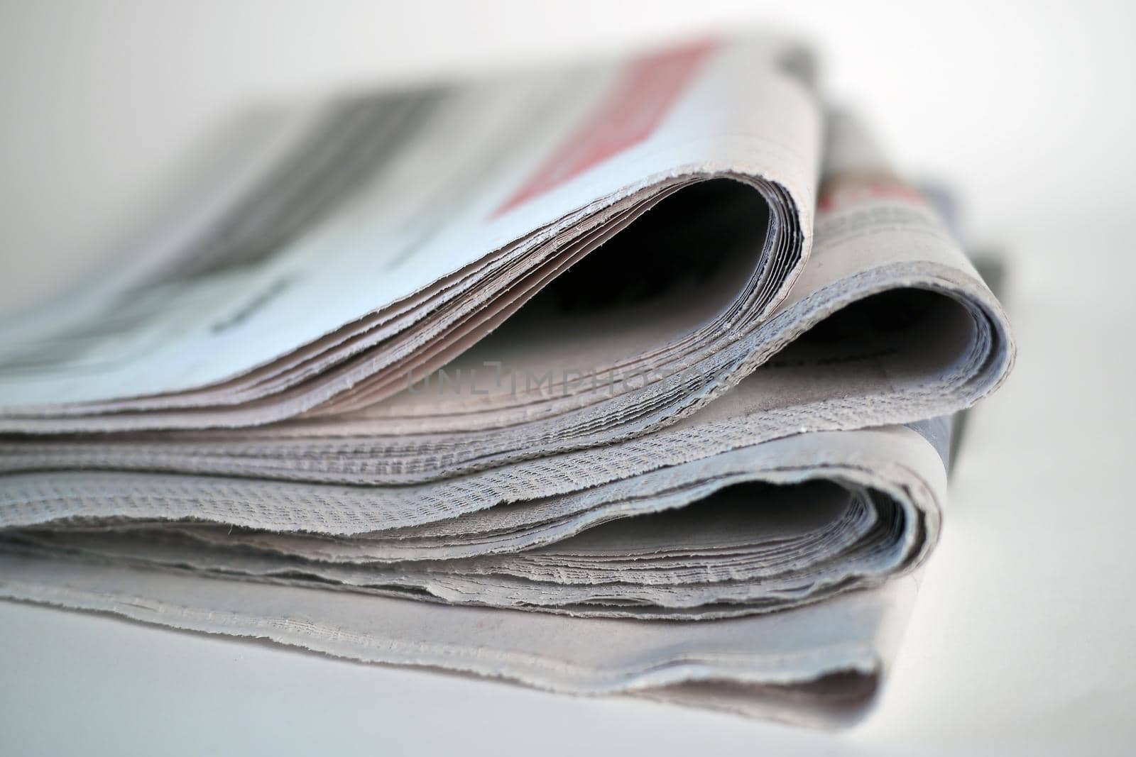 Stack of newspapers on white background