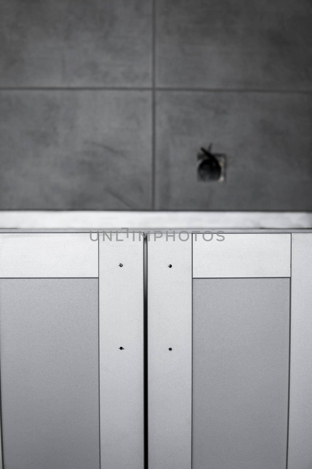 Lower custom kitchen cabinets installation with a furniture facades mdf. Gray modular kitchen from chipboard material on a various stages of installation. A frame furniture fronts mdf profile