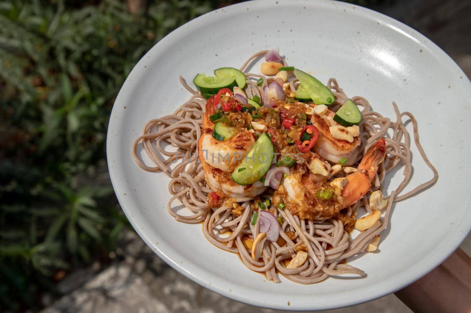 Udon and prawn spicy salad served on white plate. Healthy eating food, Copy space, Selective focus.