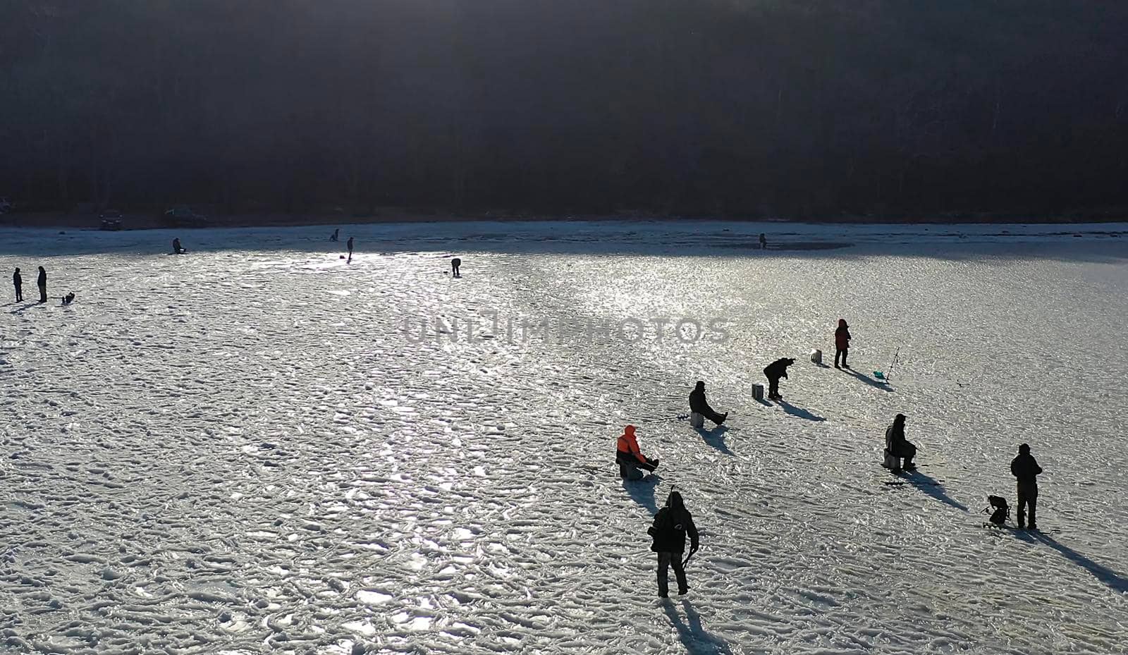 Vladivostok, Russia-December 12, 2018: Aerial view of a frozen Bay with fishermen. People are standing on the surface of white ice.