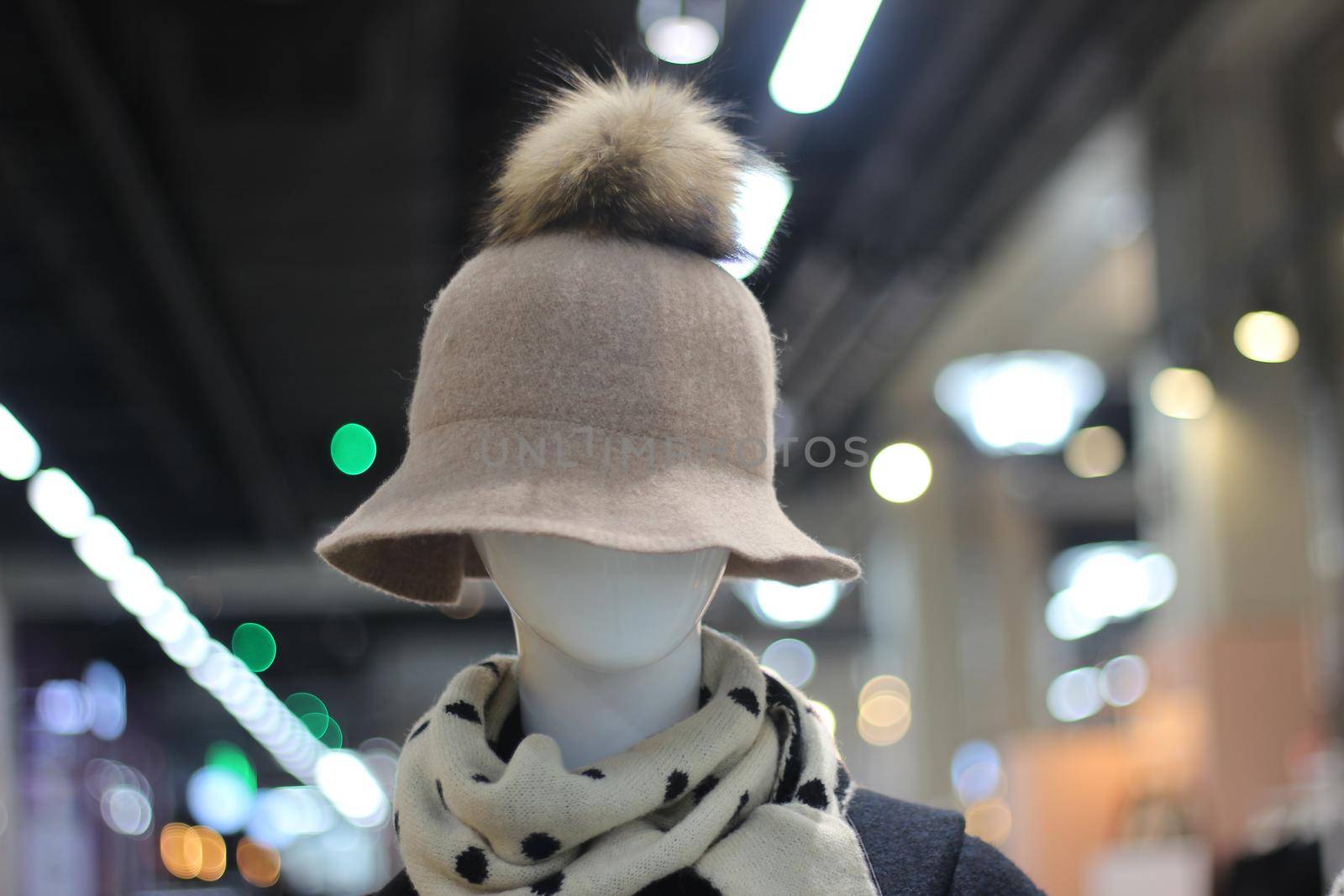 Woolen white hat on a mannequin head displayed in a mall by Photochowk