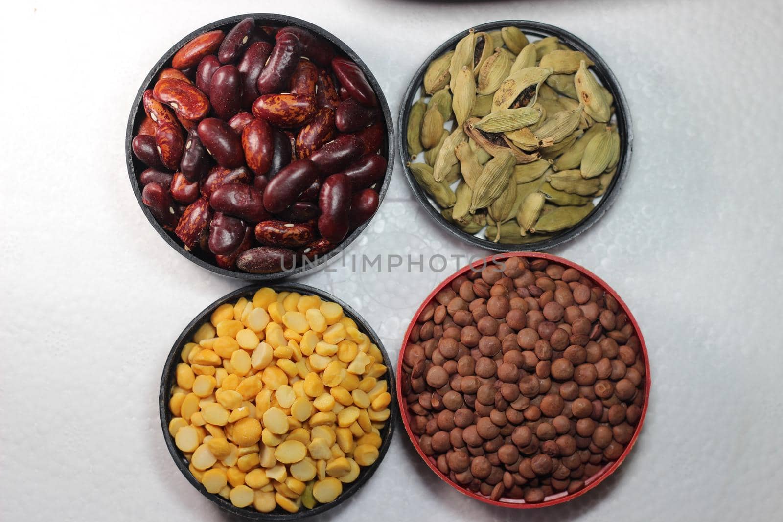 Top view of assortment of cereals, and cardamom. Collection of different spices and cereals.