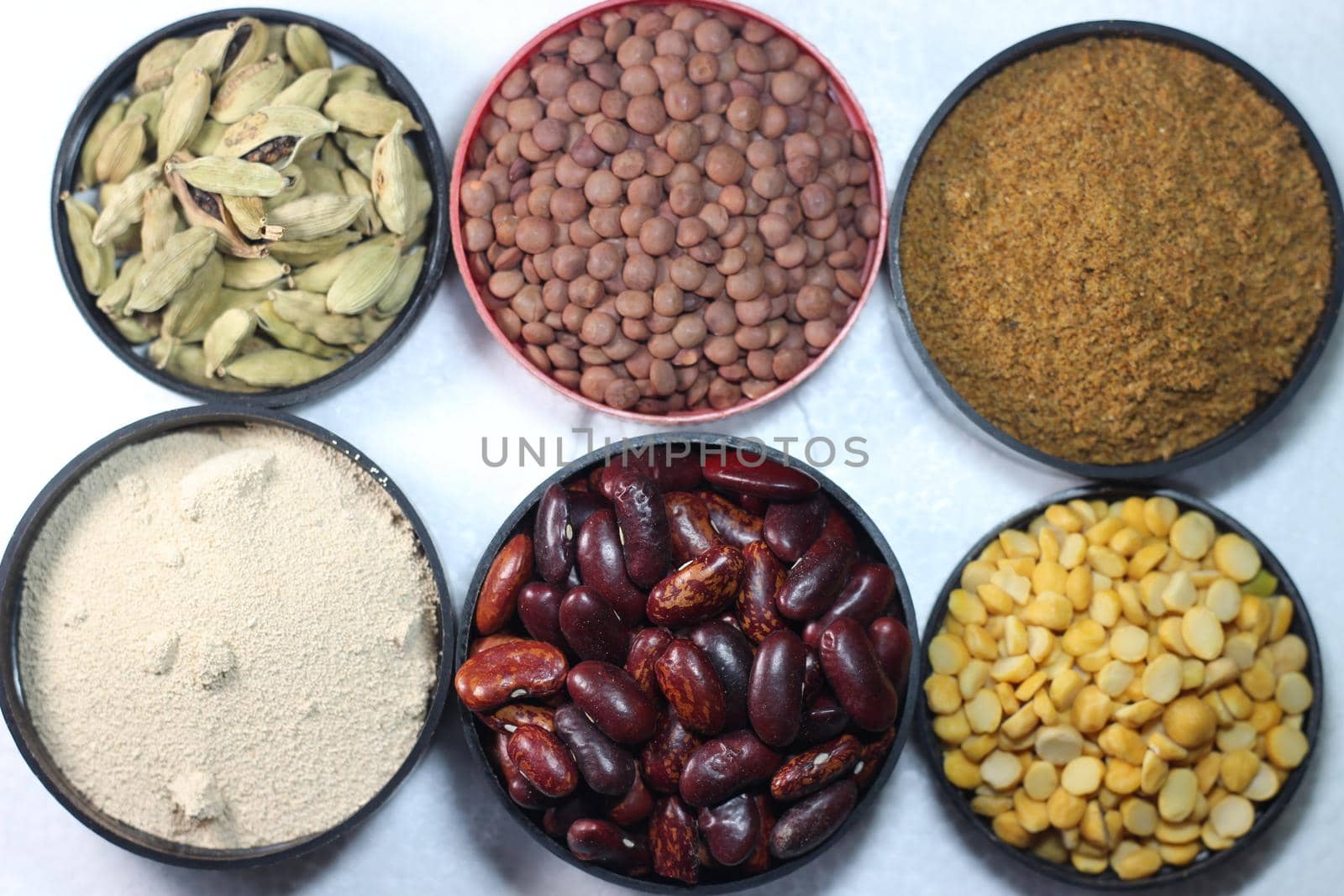 Top view of assortment of cereals, and cardamom. Collection of different spices and cereals.