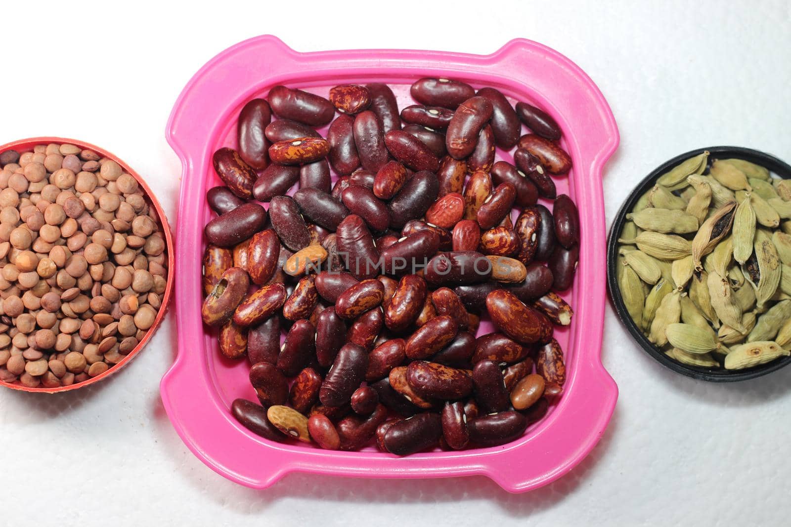 Top view of assortment of cereals, and cardamom. Collection of different spices and cereals.