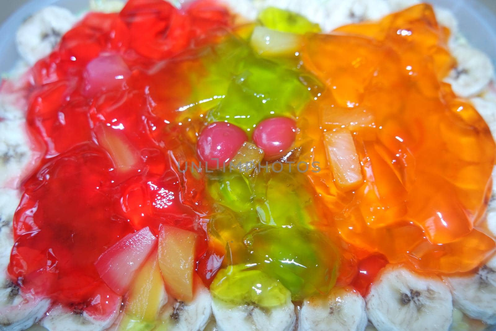 Creamy custard jelly sweet dish with different slices layered on surface by Photochowk