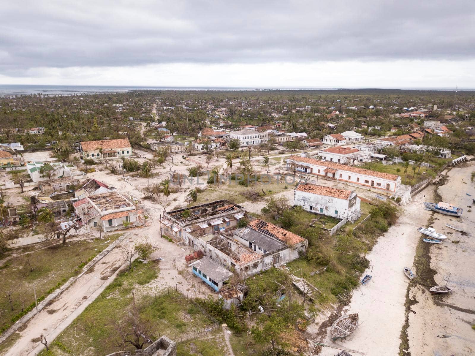 Aerial overhead houses on a tropical island, damaged by a cyclone