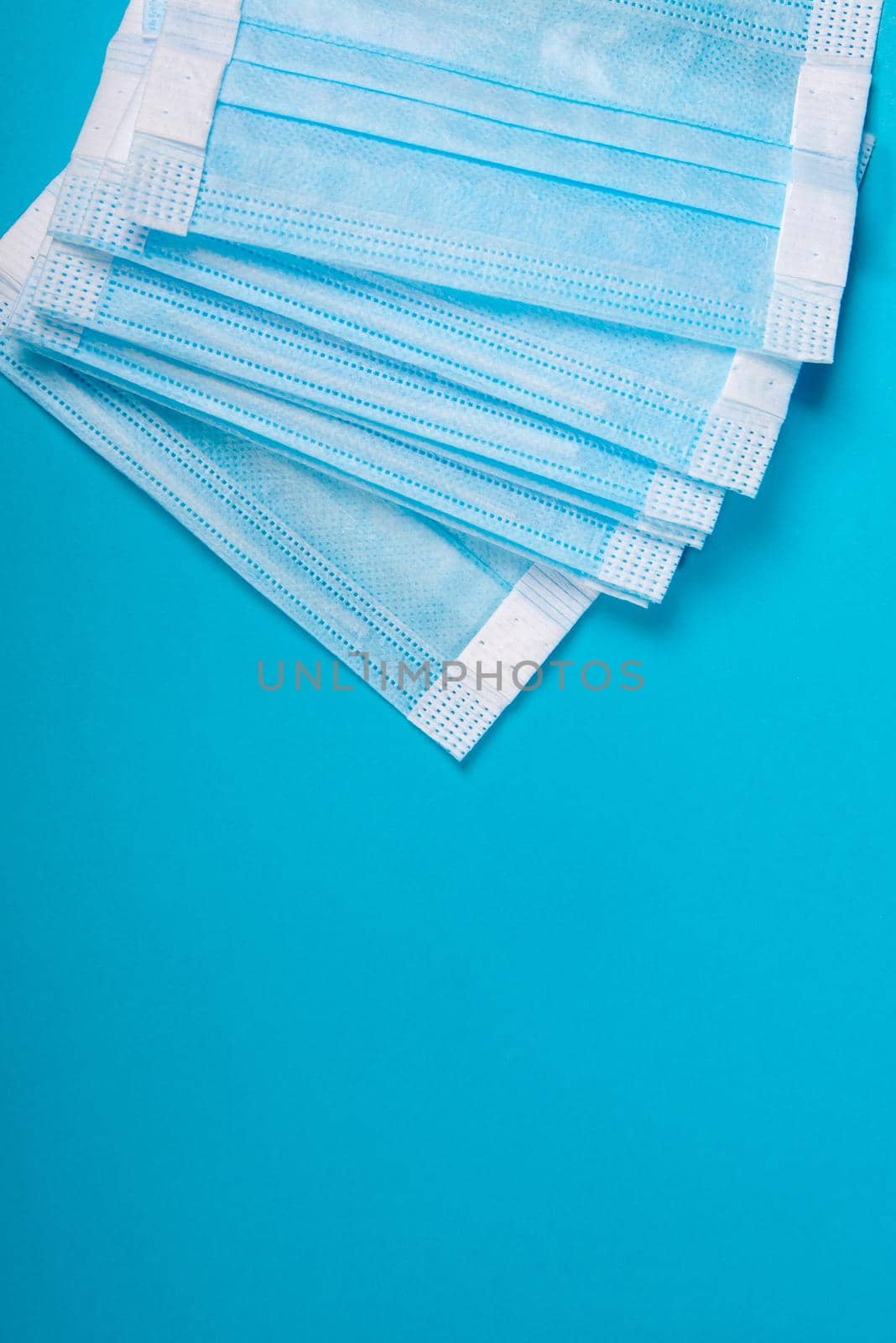 Medical mask on a blue background with copy space.