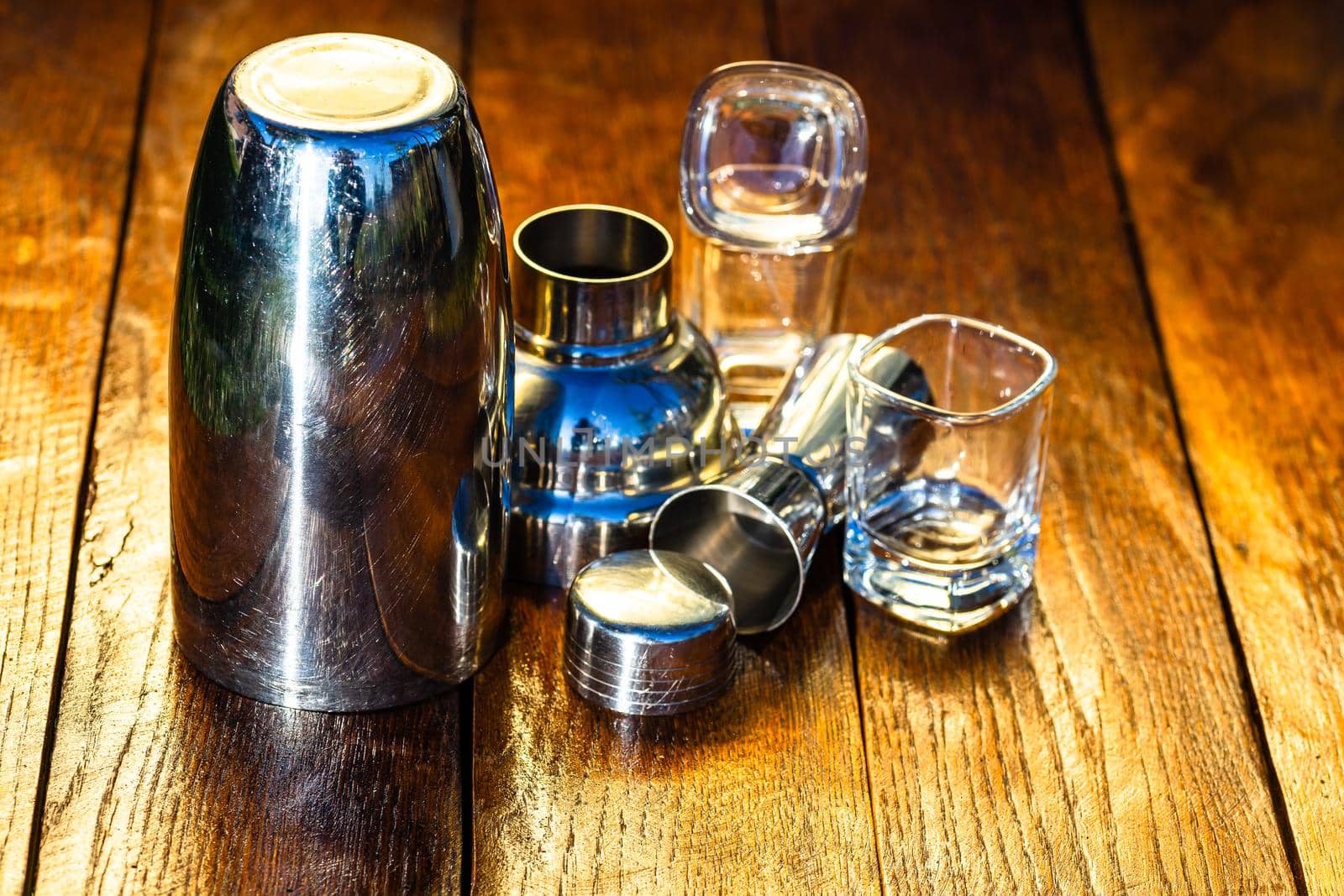 Bar ustensils, drink concept. Cocktail shaker accessories on a wooden board.