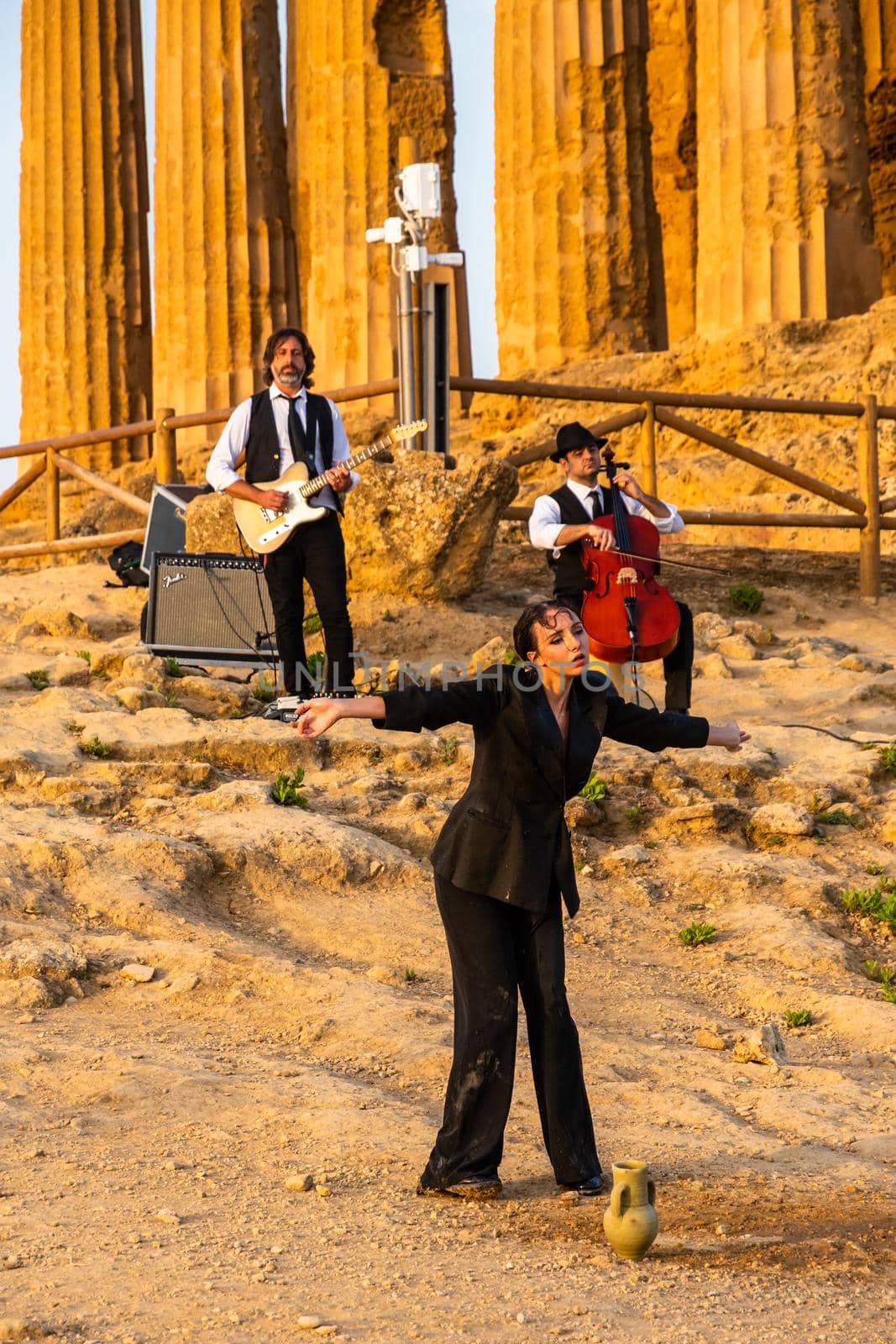 Agrigento, Italy - 14 8 2020: Artists performance at dusk at Concordia Temple by mauricallari