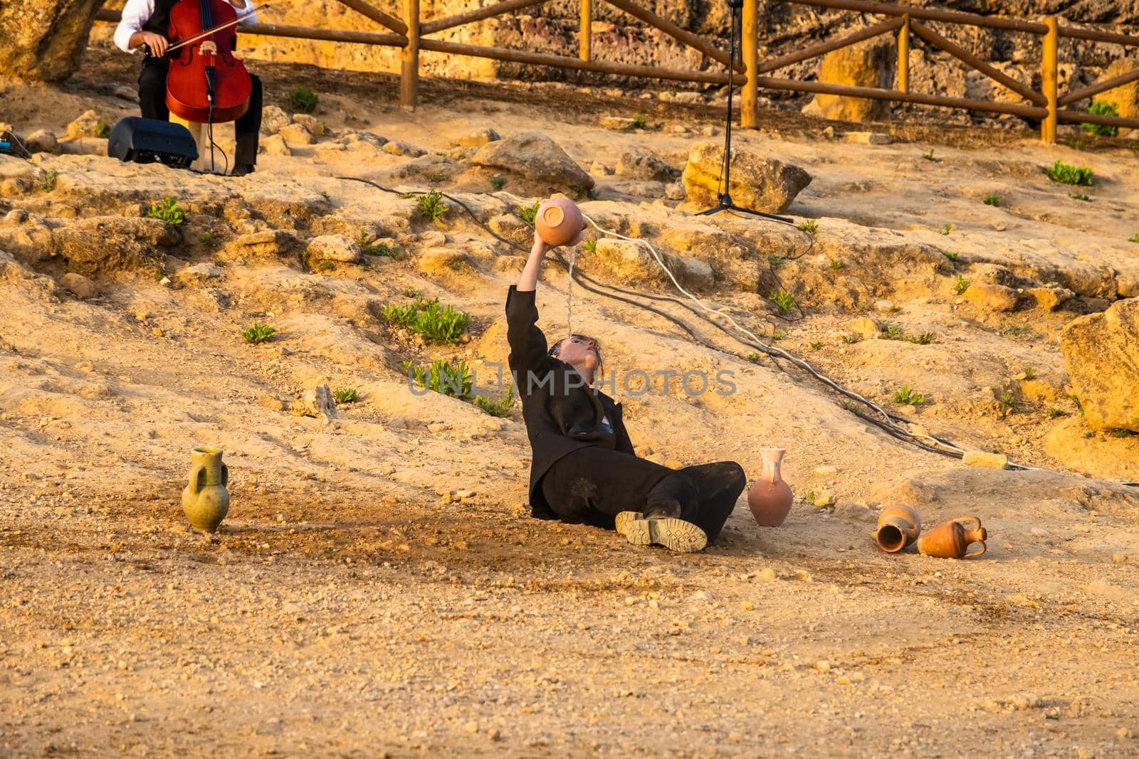 Agrigento, Italy - 14 8 2020: Artists performance at dusk at Concordia Temple by mauricallari