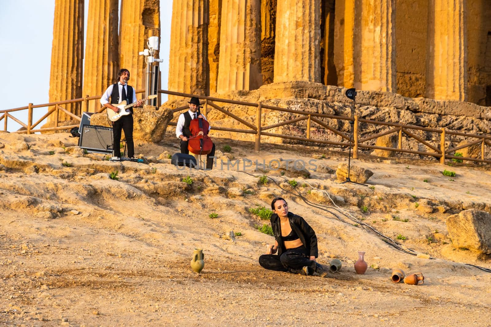 Agrigento, Italy - 14 8 2020: Artists performance at dusk at Concordia Temple by mauricallari