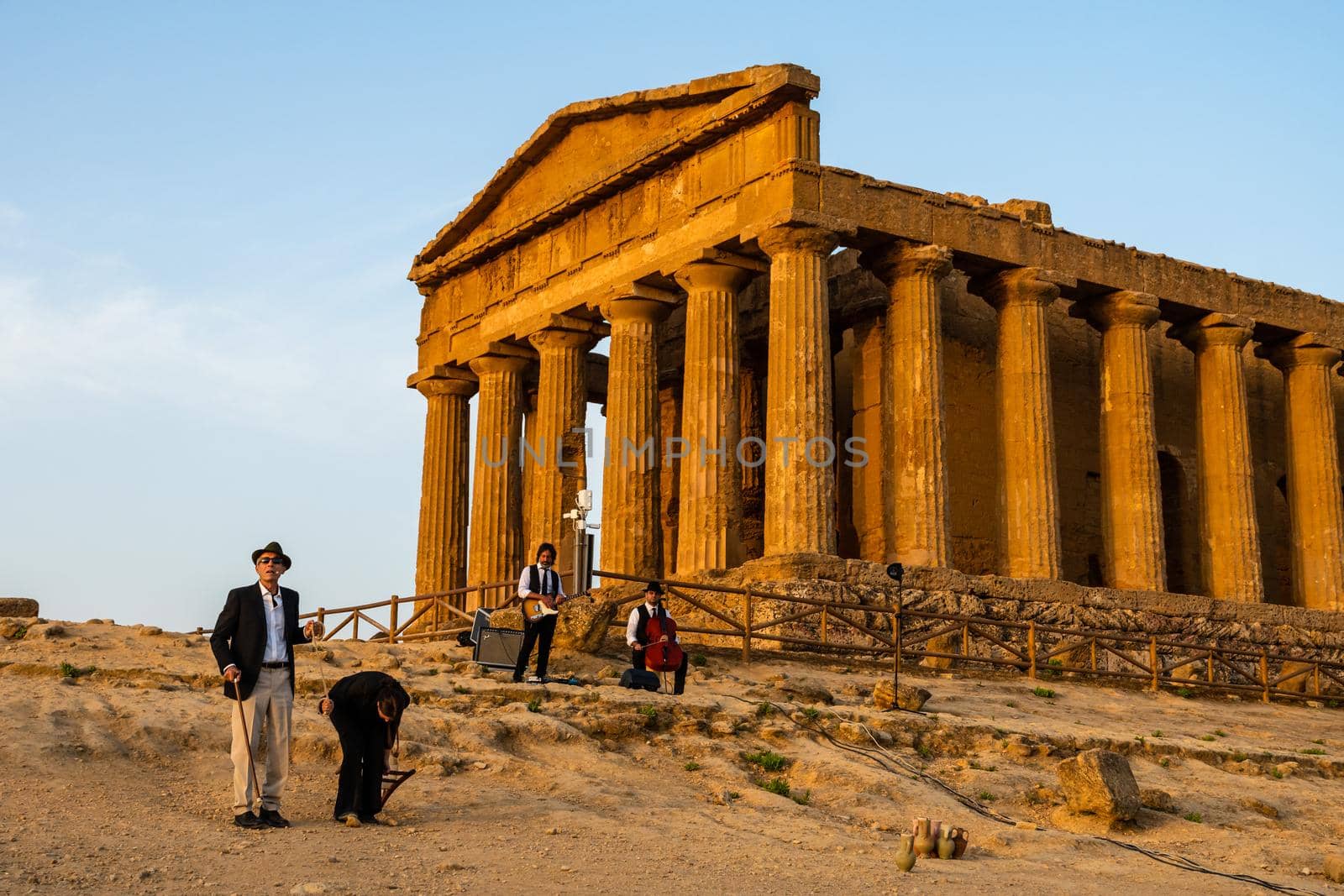 Agrigento, Italy - 14 8 2020: Artists performance at dusk at Concordia Temple by mauricallari