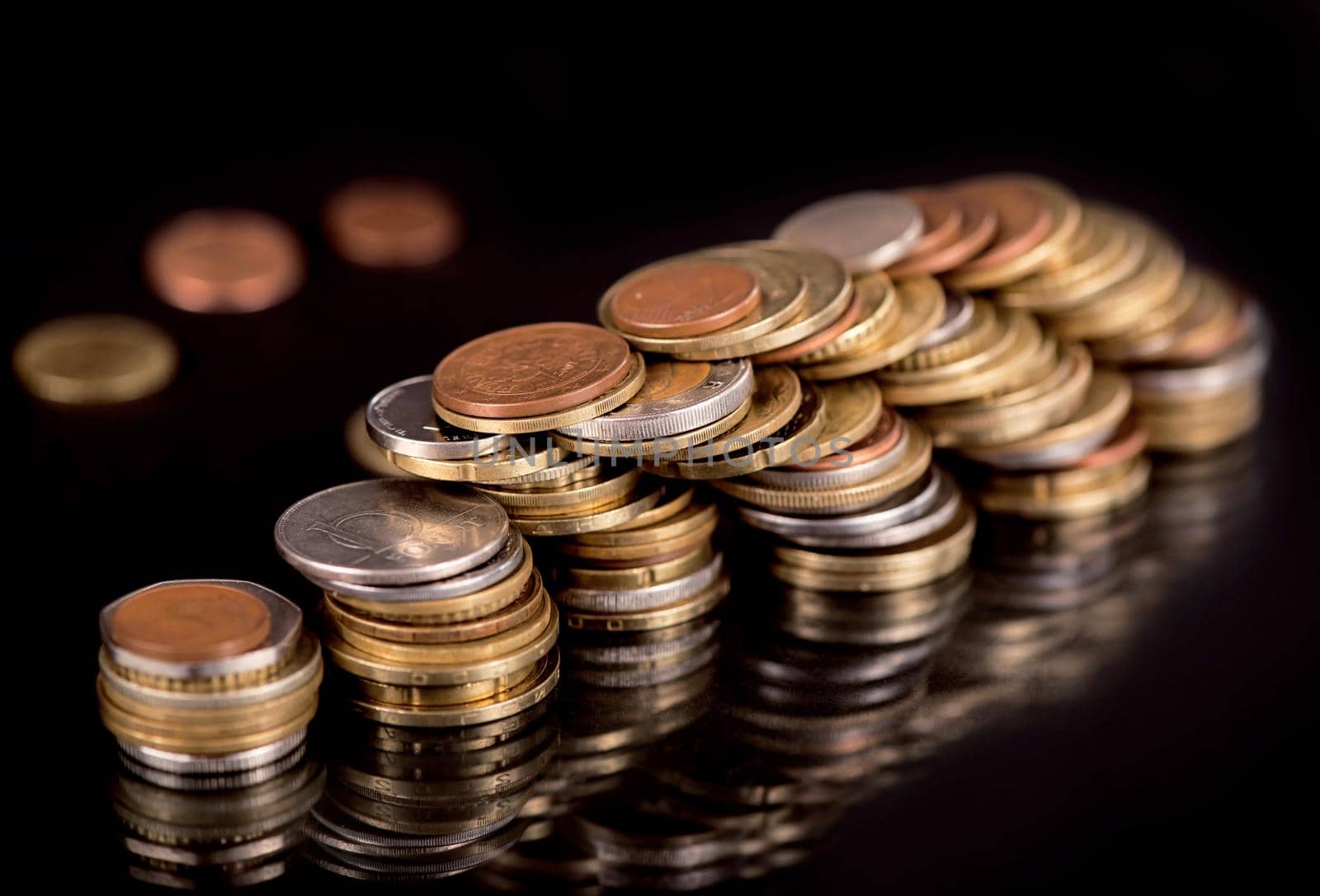 Stacks cf different country coins on black by aprilphoto