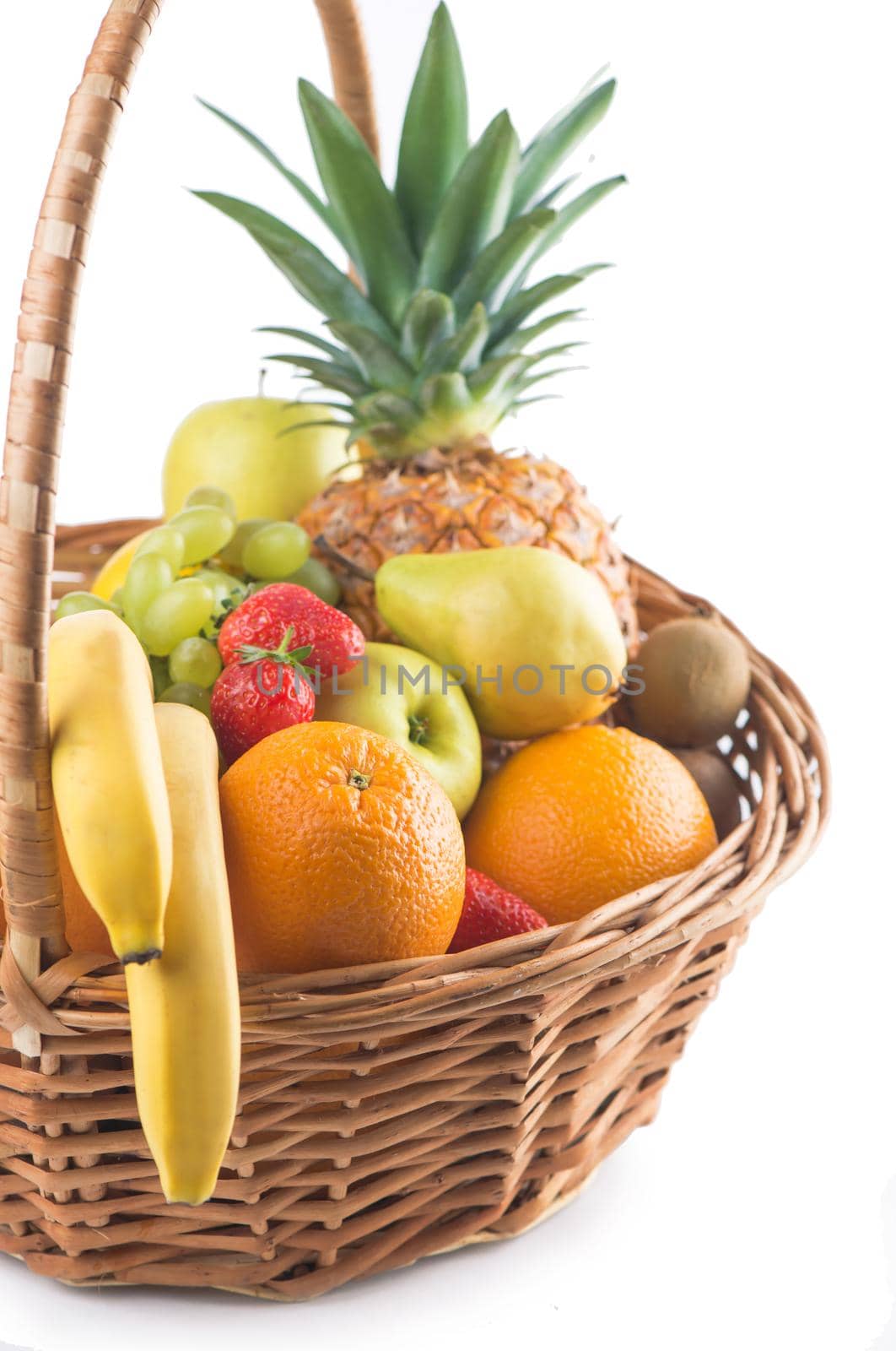 Fresh fruit in the basket against a white