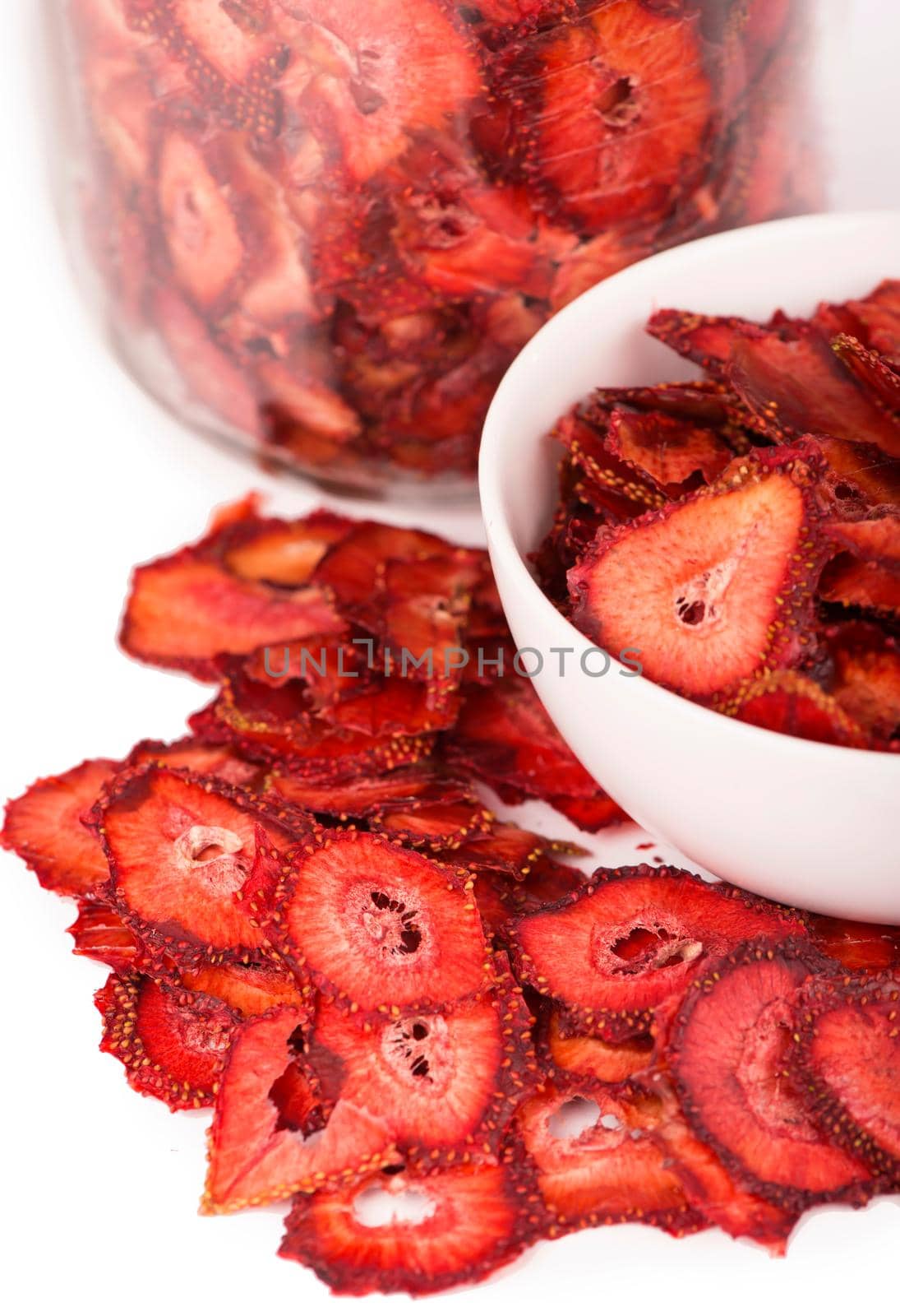 dry strawberry in a white plate, strawberry fruit chips isolated on white background by aprilphoto